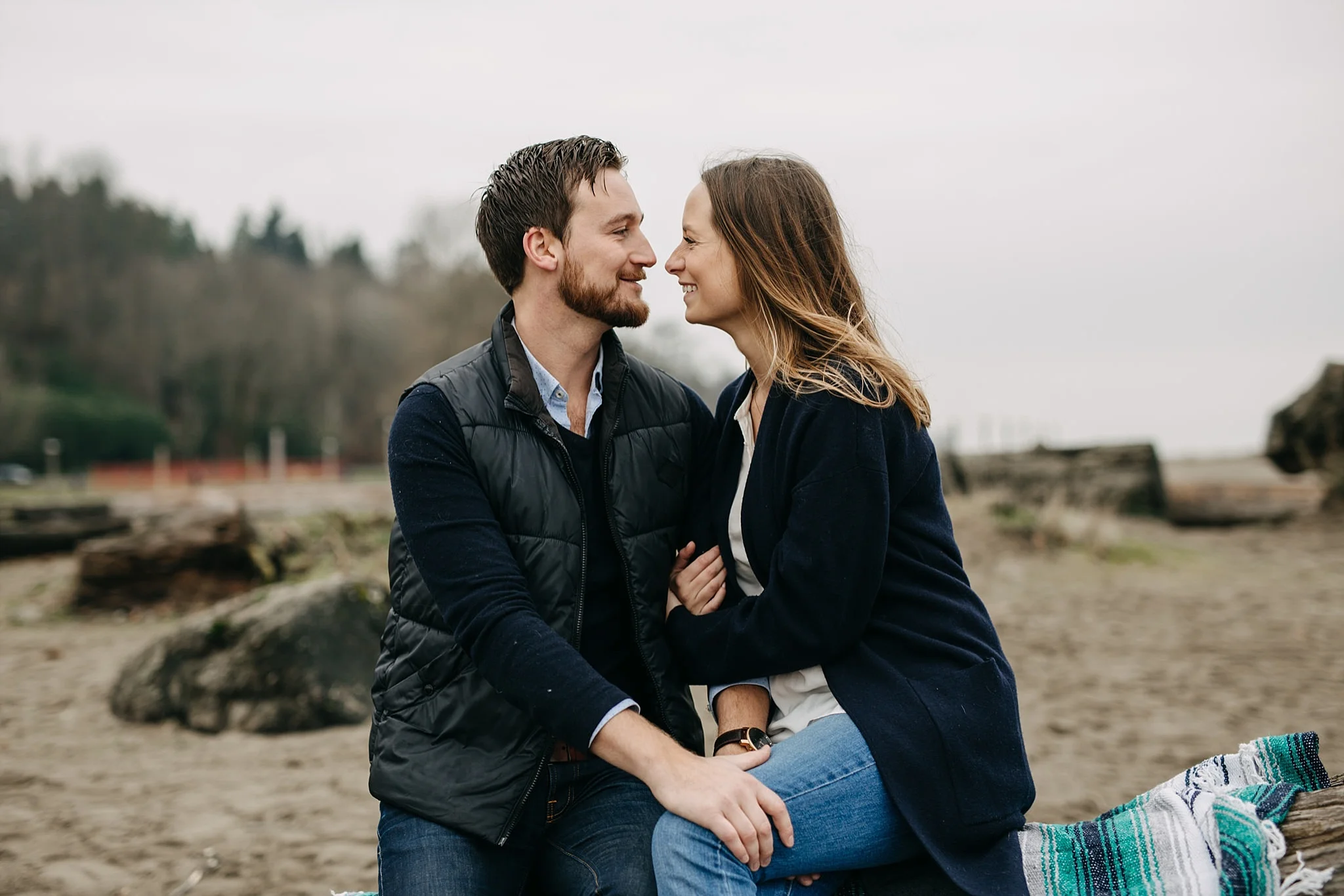 couple intimate moment spanish banks beach engagement blanket log