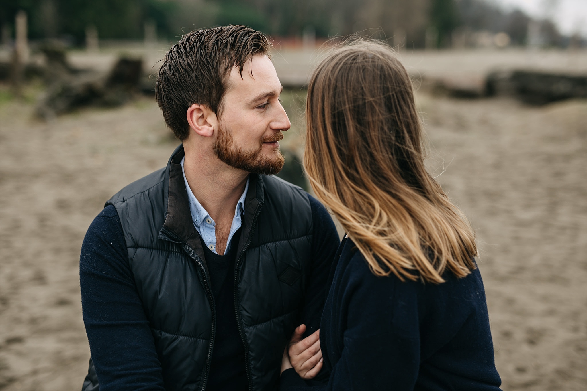 candid intimate moment between couple engagement spanish banks beach