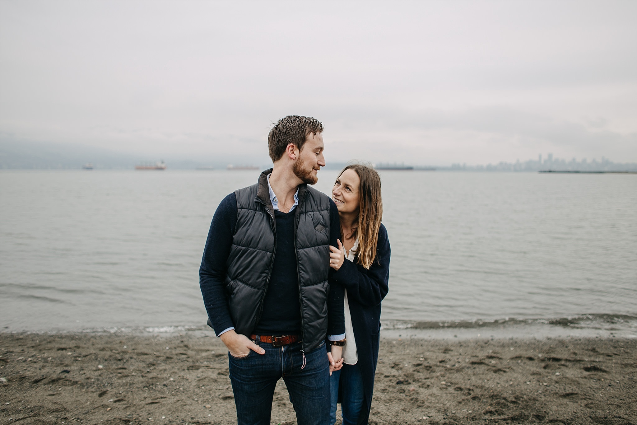couple looking at each other spanish banks beach engagement