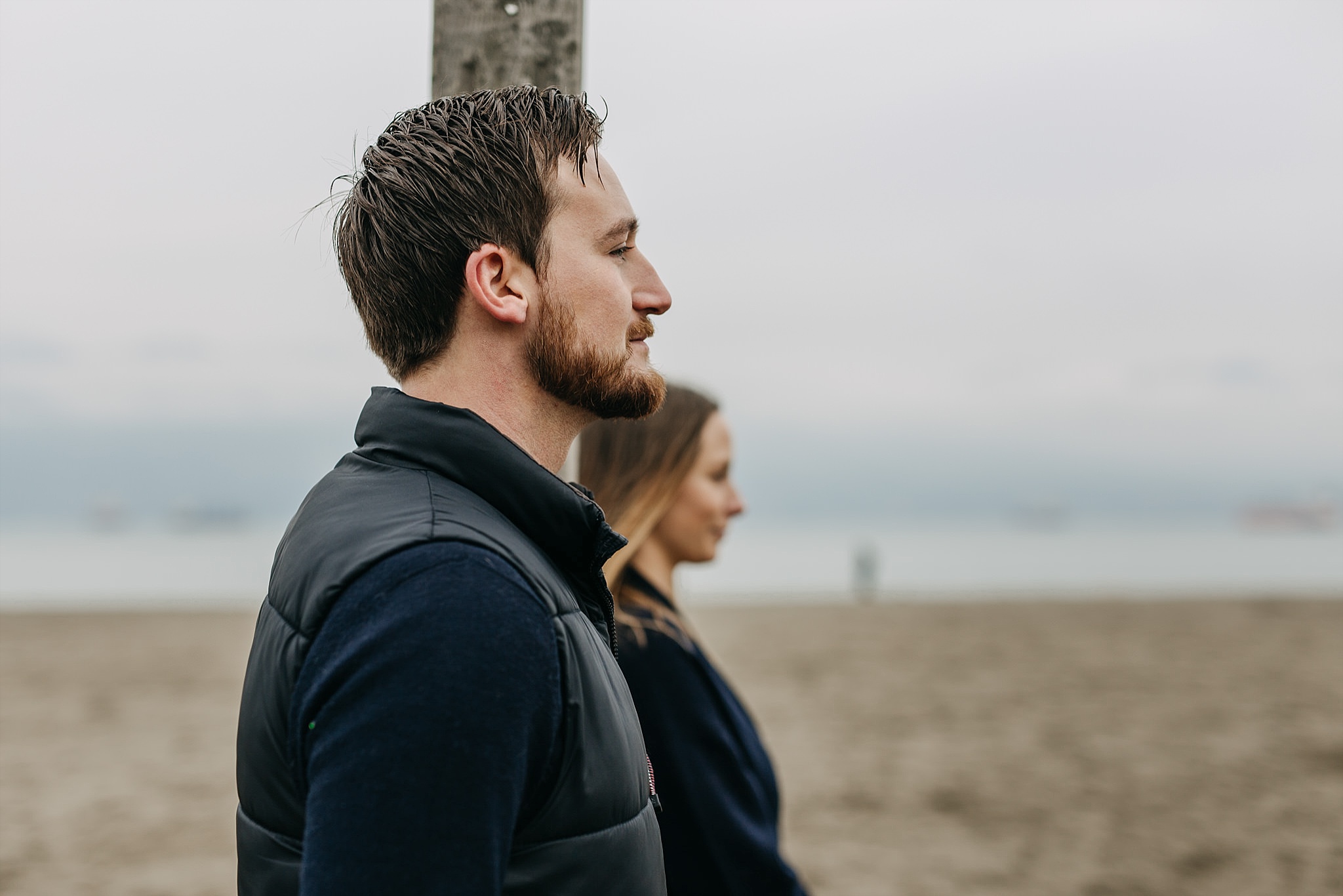 couple standing side by side on beach spanish banks engagement