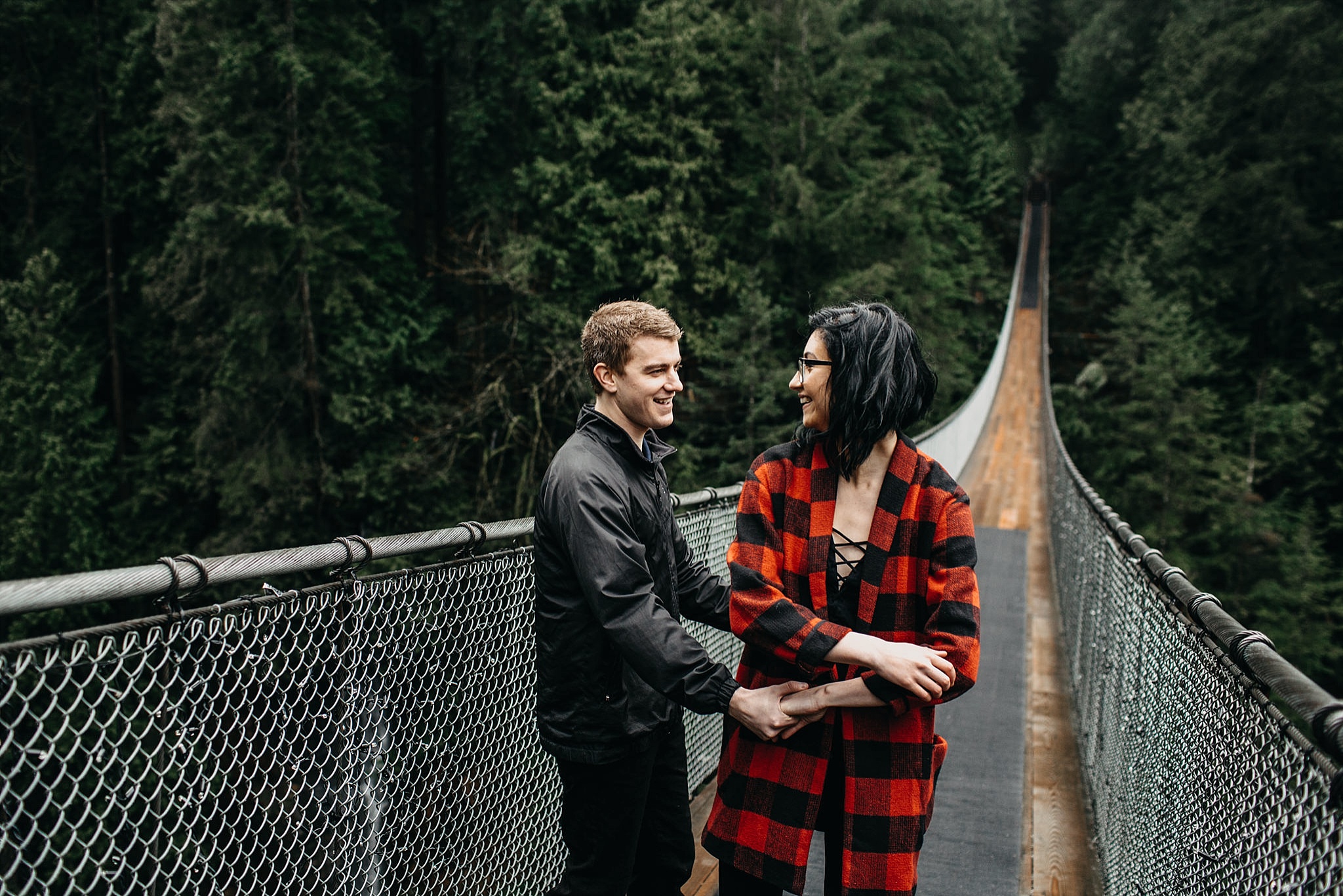 couple dancing on capilano suspension bridge engagement candid photos