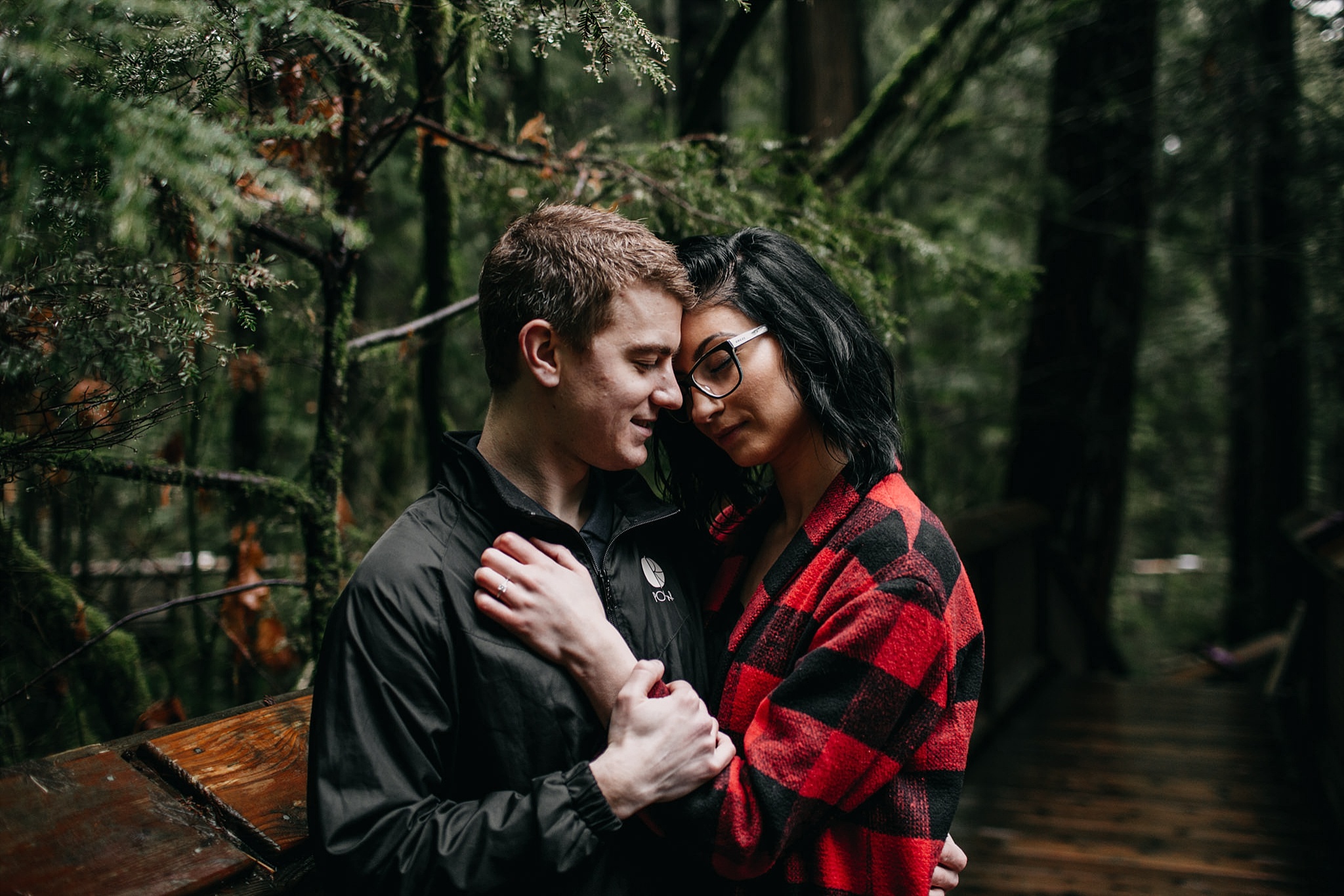 couple leaning into each other intimate moment capilano suspension bridge