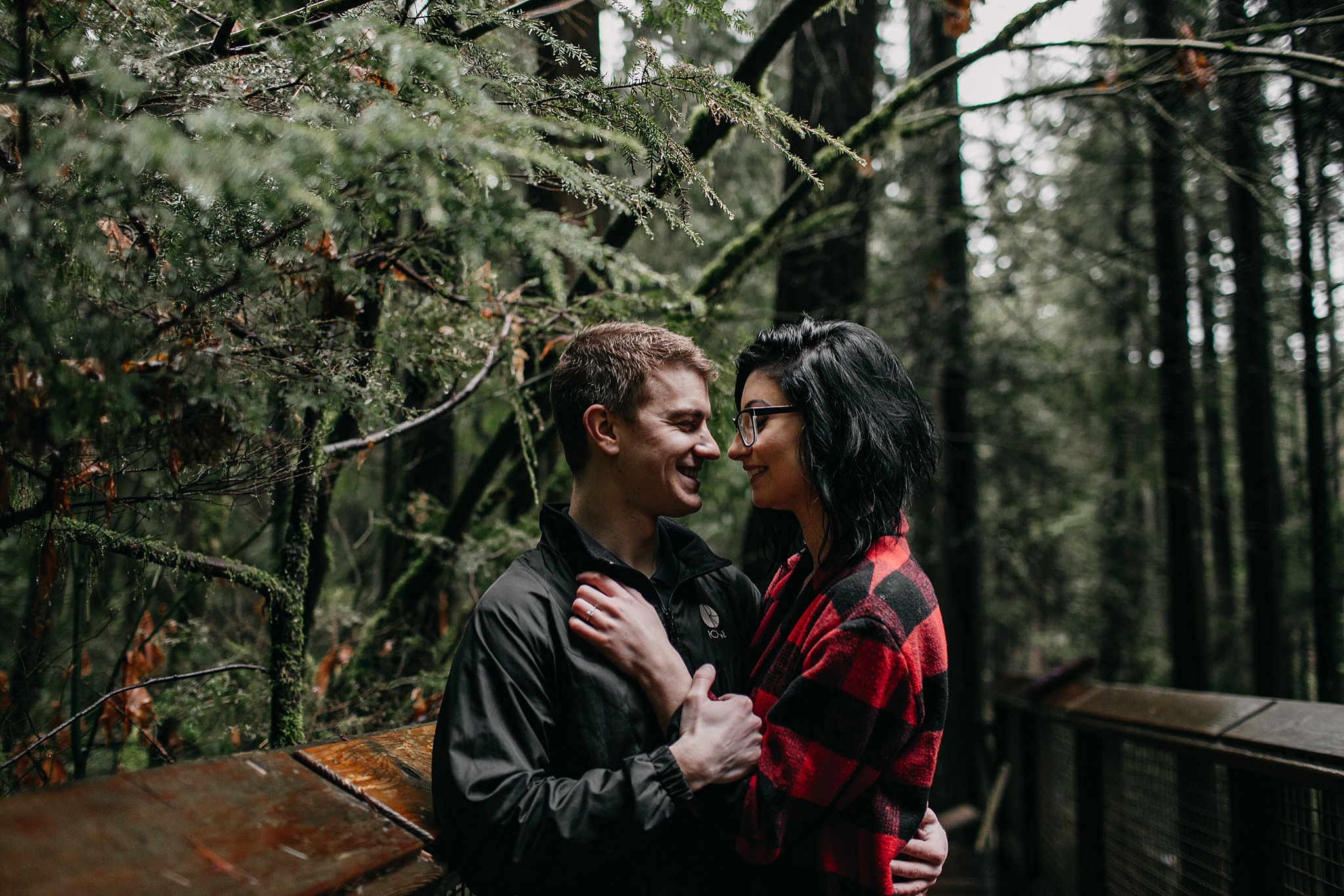 couple intimate moment capilano suspension bridge engagement photos