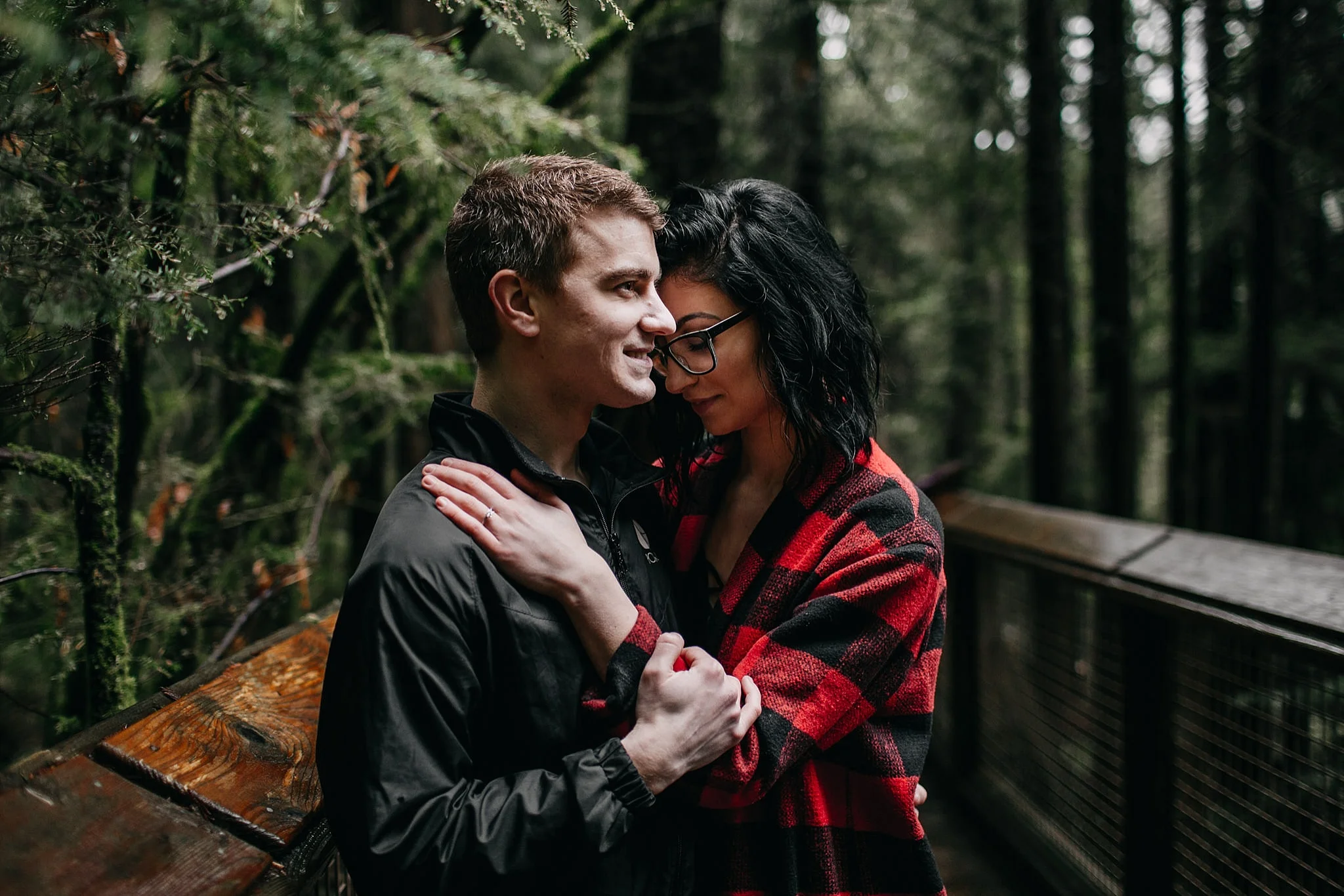 capilano suspension bridge engagement photos couple amongst trees