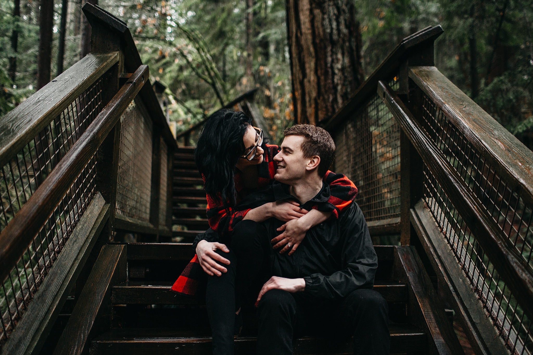 couple sitting on steps engagement photos capilano suspension bridge