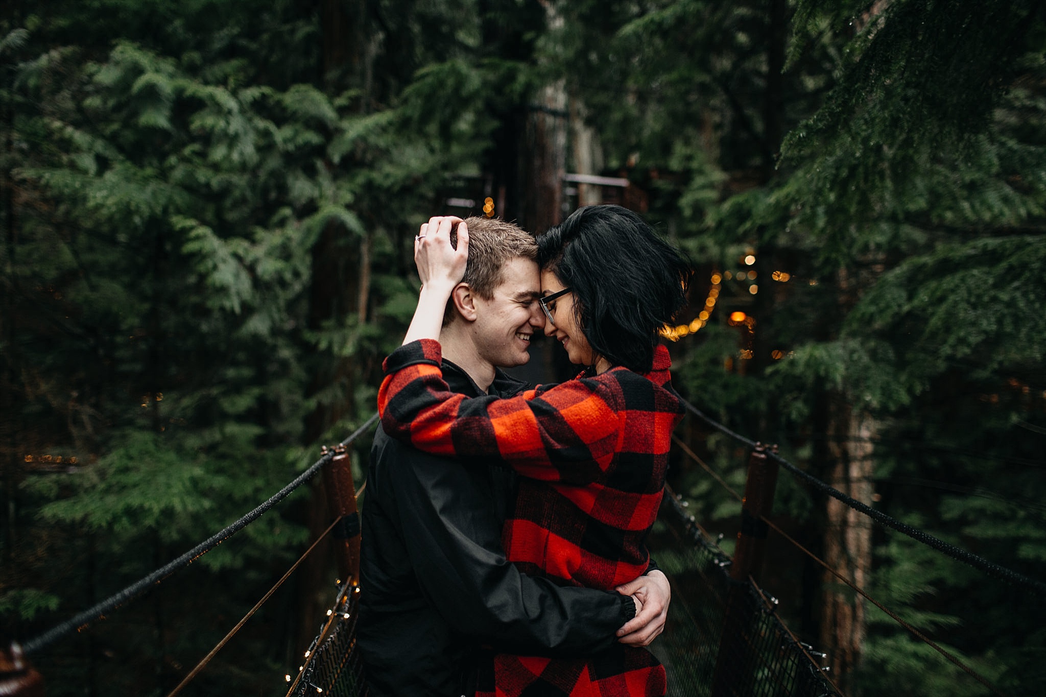 couple hugging close capilano suspension bridge engagement