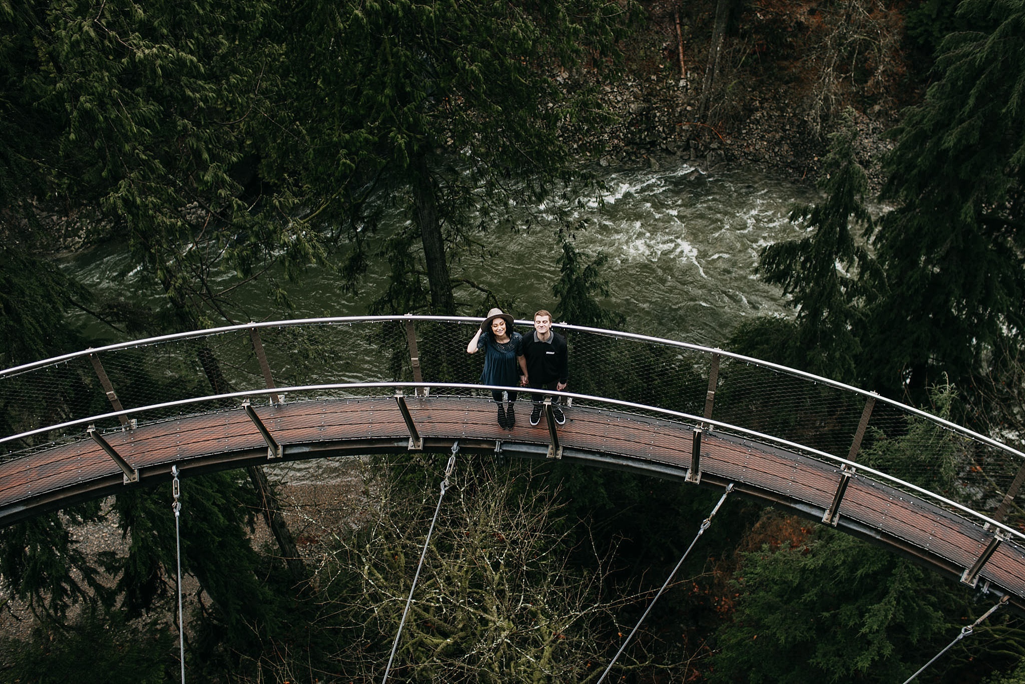 couple looking up on cliff walk capilano suspension bridge north vancouver engagement