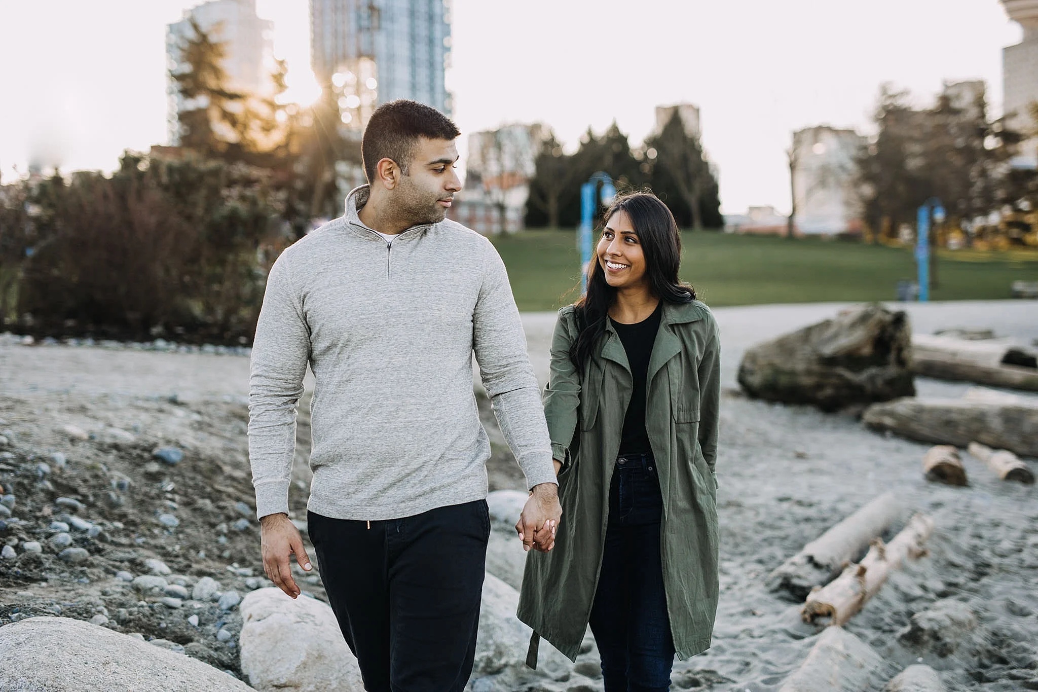 couple walking on beach crab park engagement sunset city