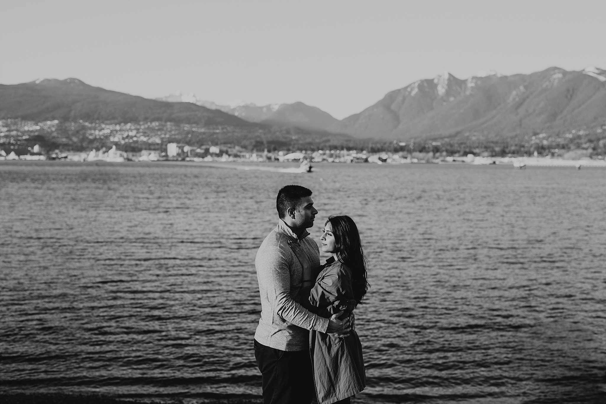 couple by ocean vancouver mountains engagement session