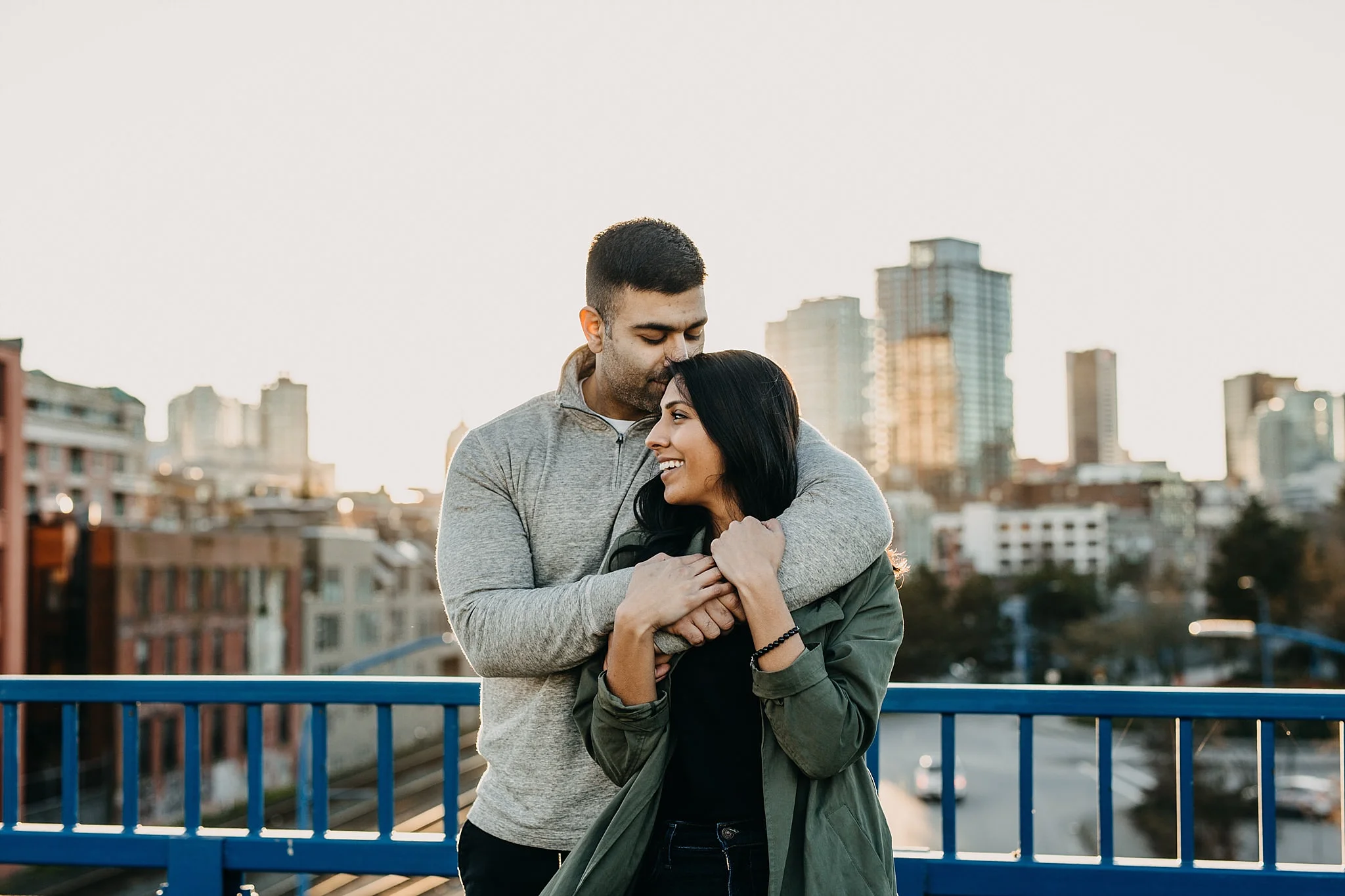 couple on bridge vancouver downtown skyline city