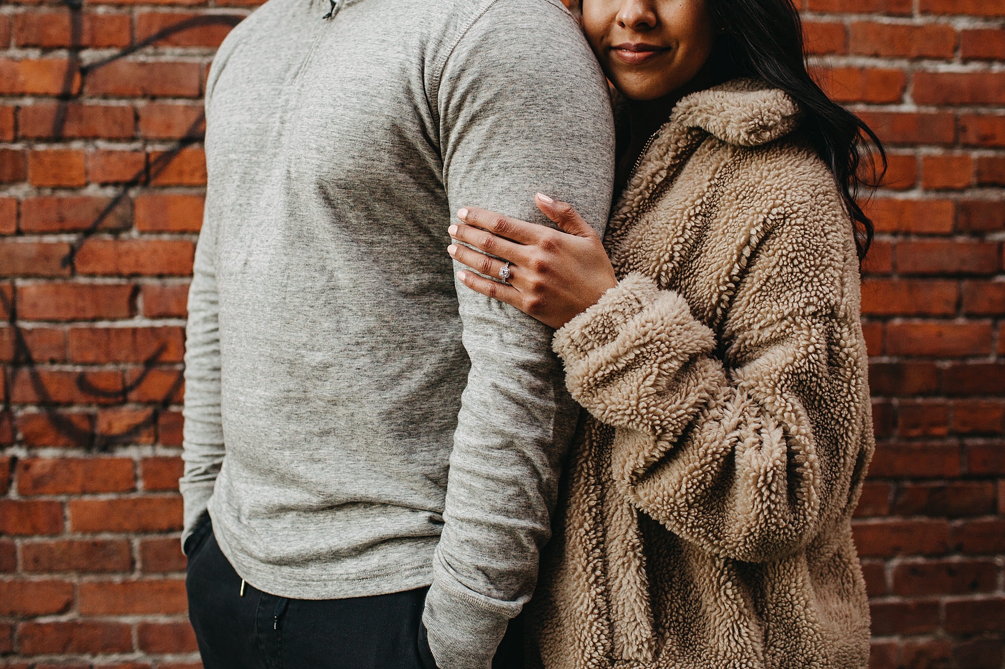 vancouver couple engagement ring urban brick wall