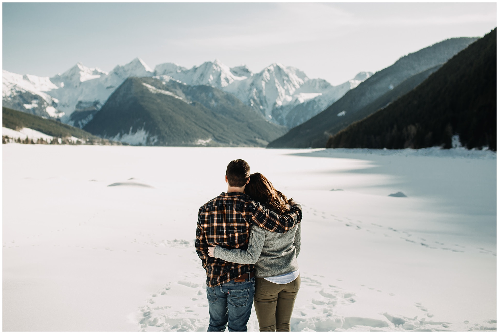 couple enjoying view of mountains at snowy jones lake 