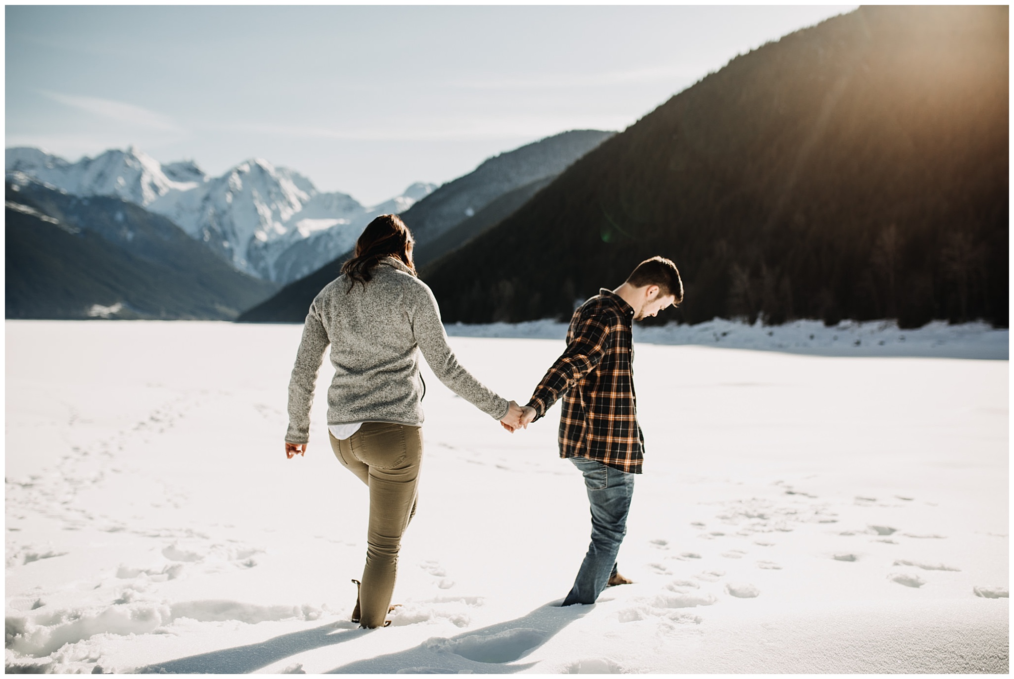 couple walking in snow jones lake engagement session