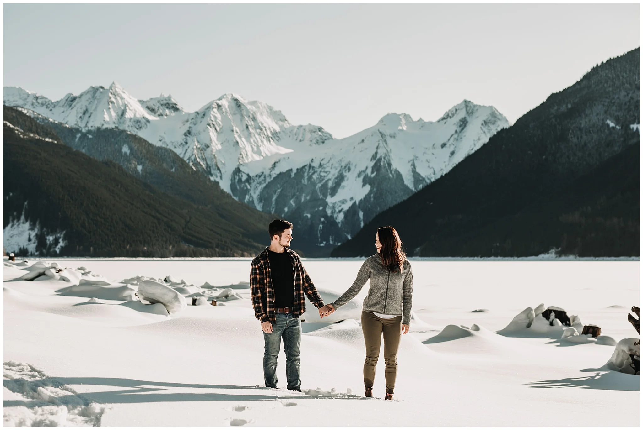 couple mountain view jones lake engagement session snow sun