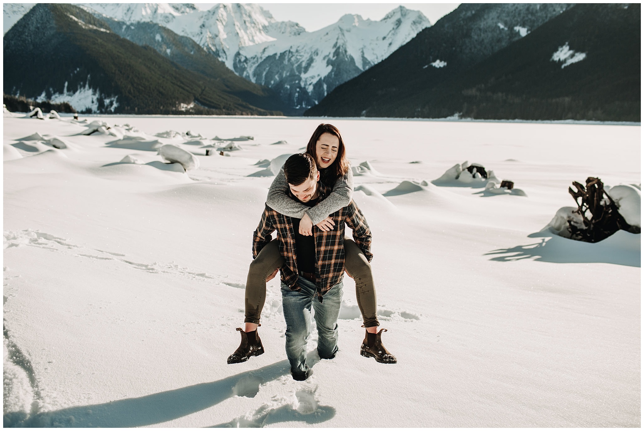 guy piggyback girl couple engagement session snowy jones lake