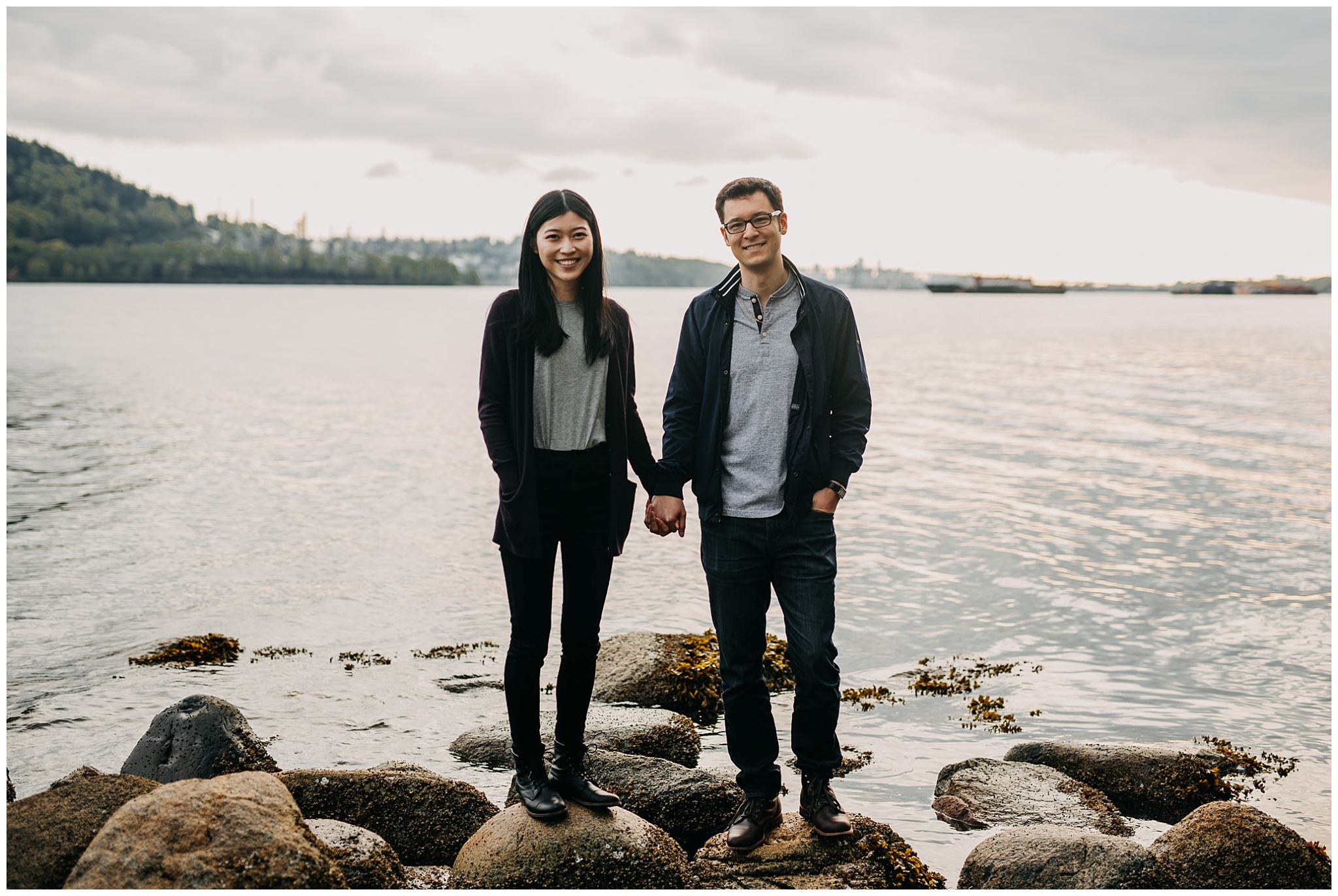  couple standing on rock smile sunset north vancouver cates park engagement session