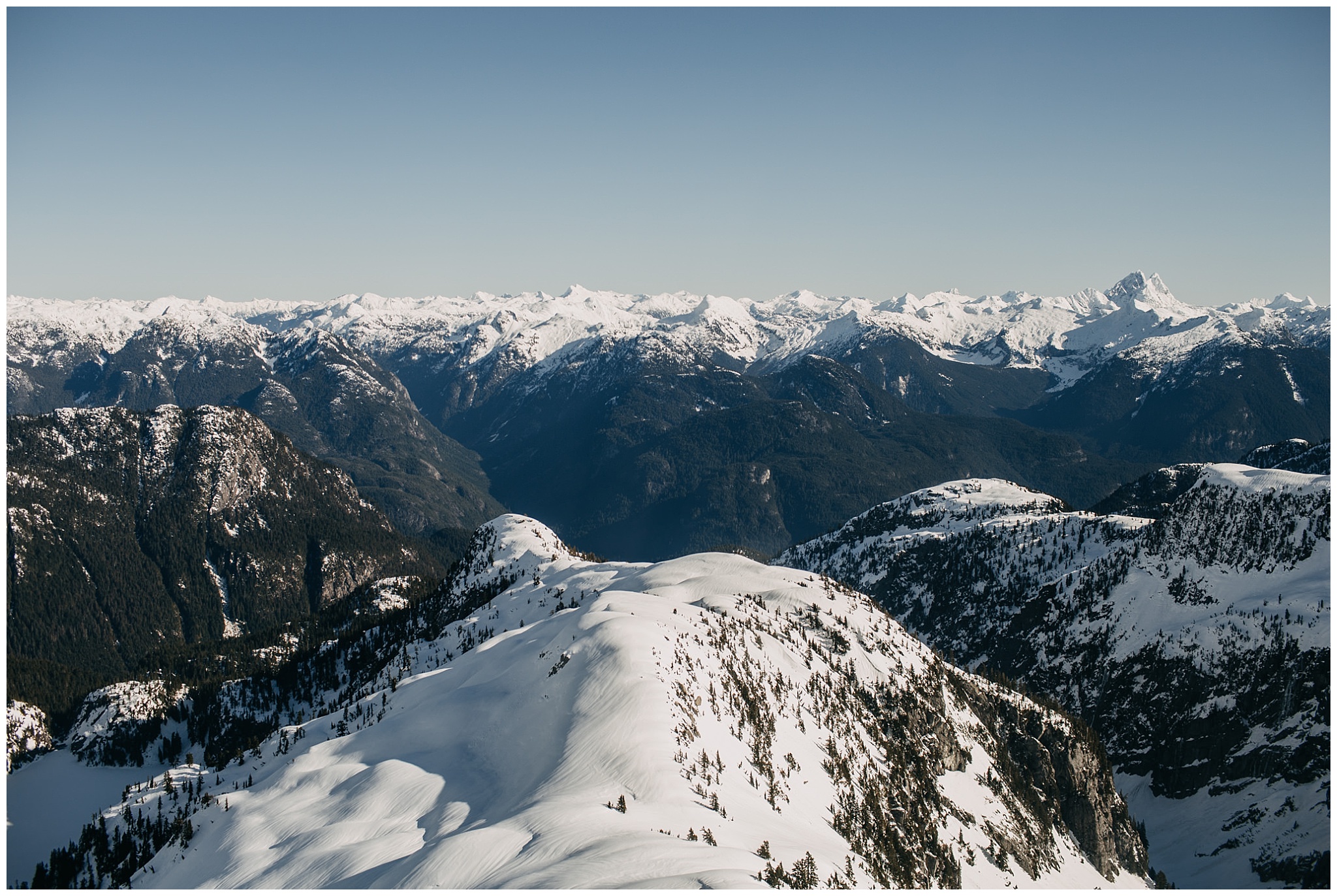 snowy mountain sky helicopters wedding portraits bride groom