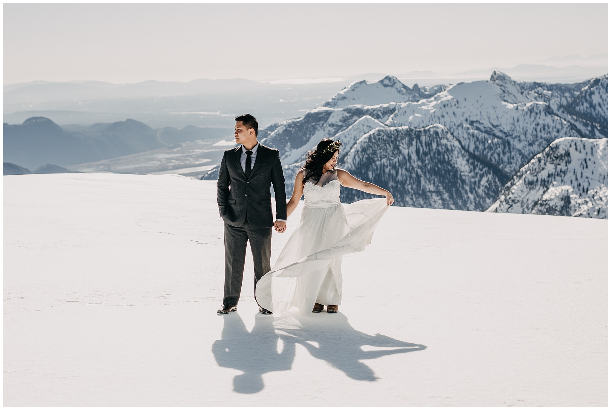bride flowy wedding dress groom portraits mountaintop sky helicopters