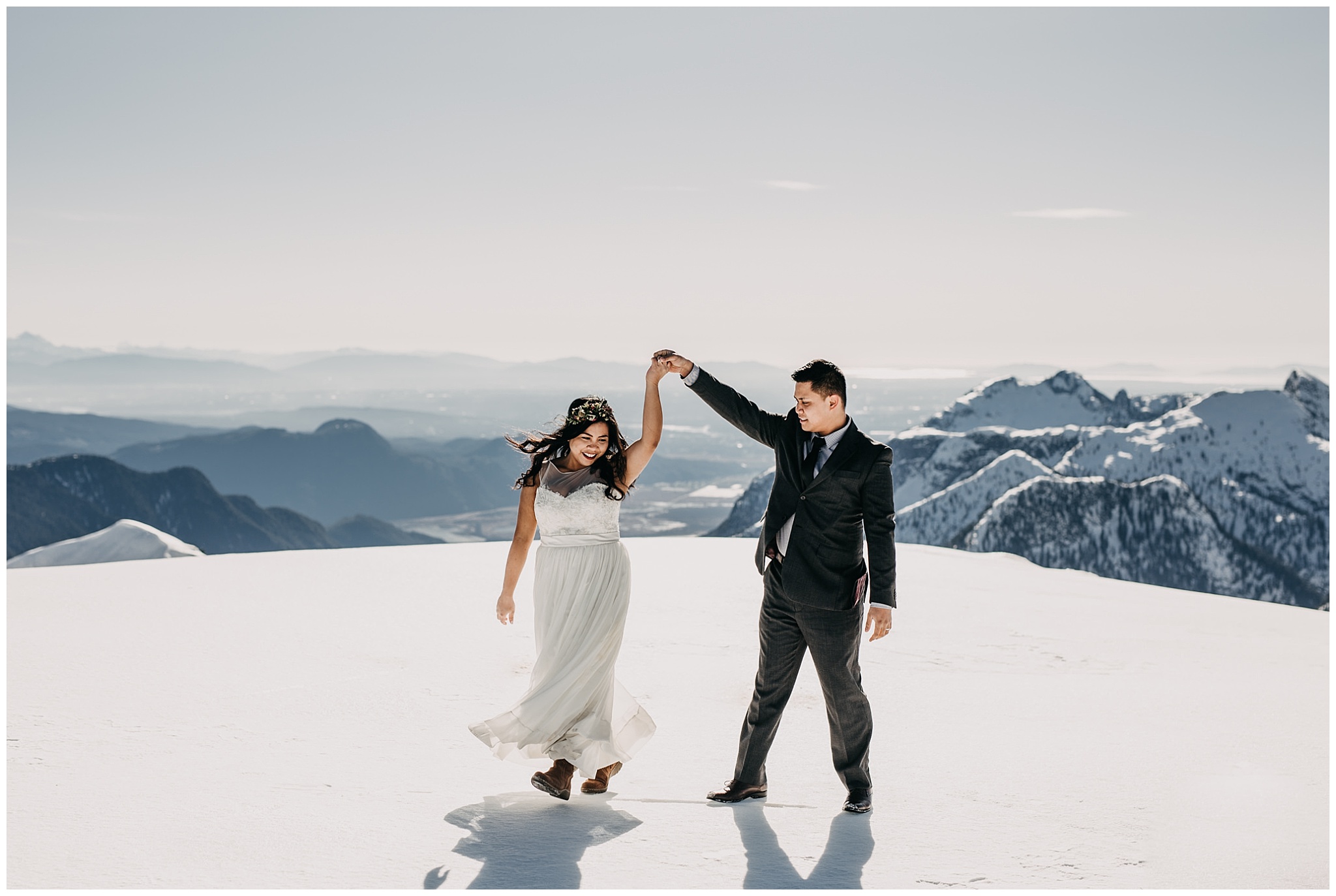 bride groom dancing on mountaintop snow sky helicopters wedding