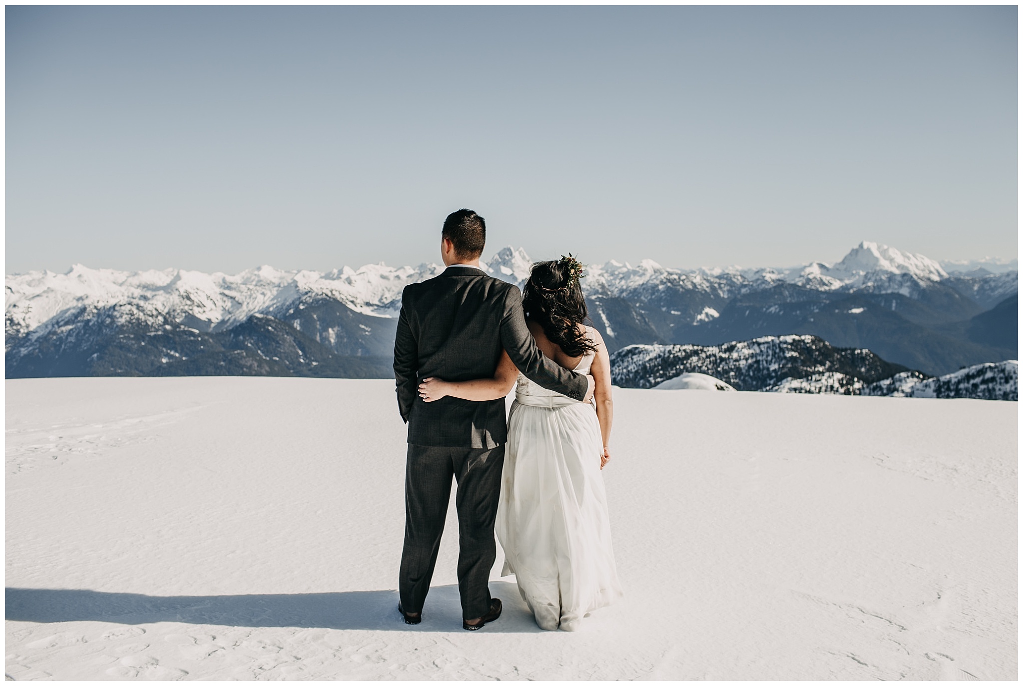 bride groom sky helicopters mountaintop snow sun wedding portraits