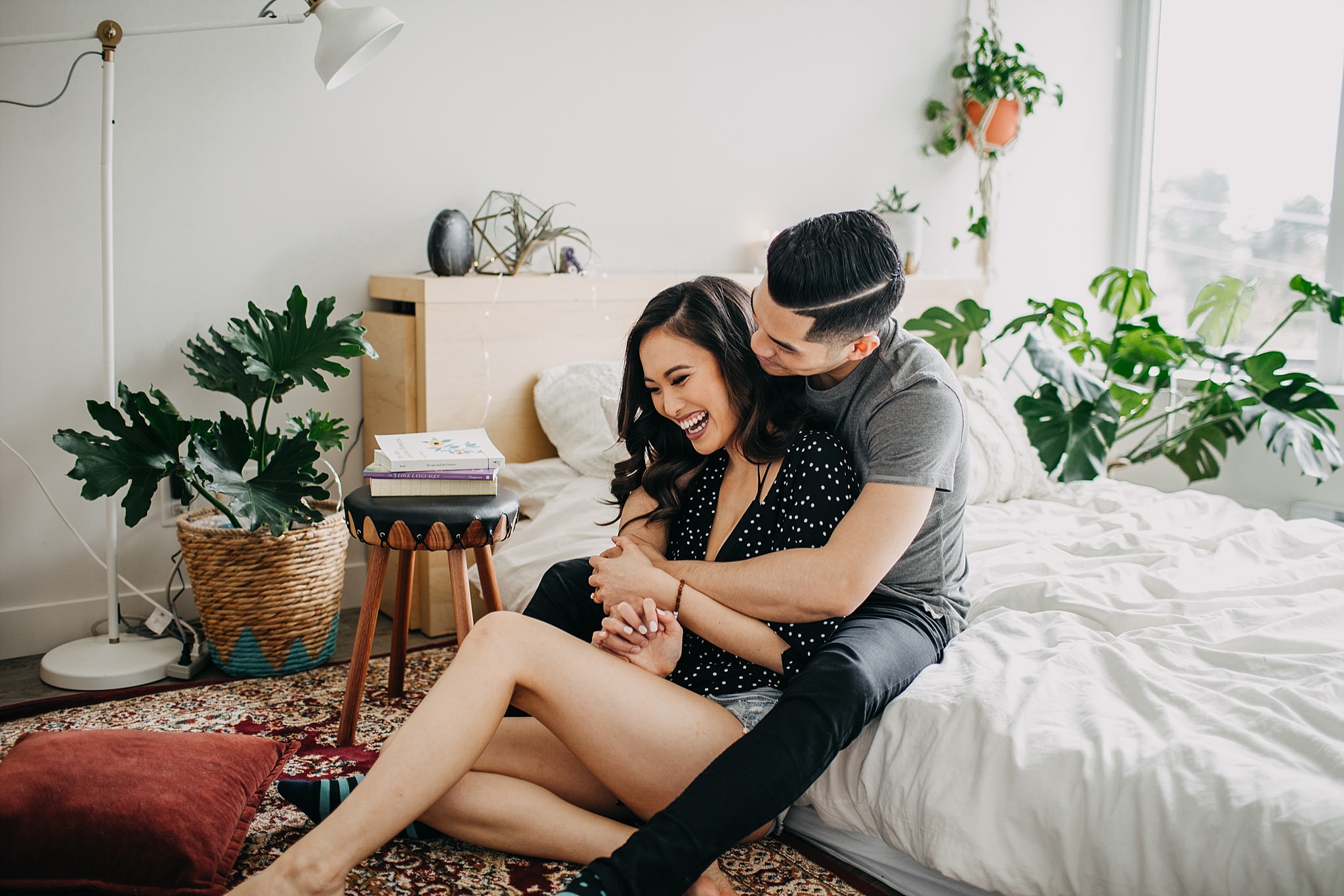 couple hug bedroom floor cuddle in home engagement session vancouver