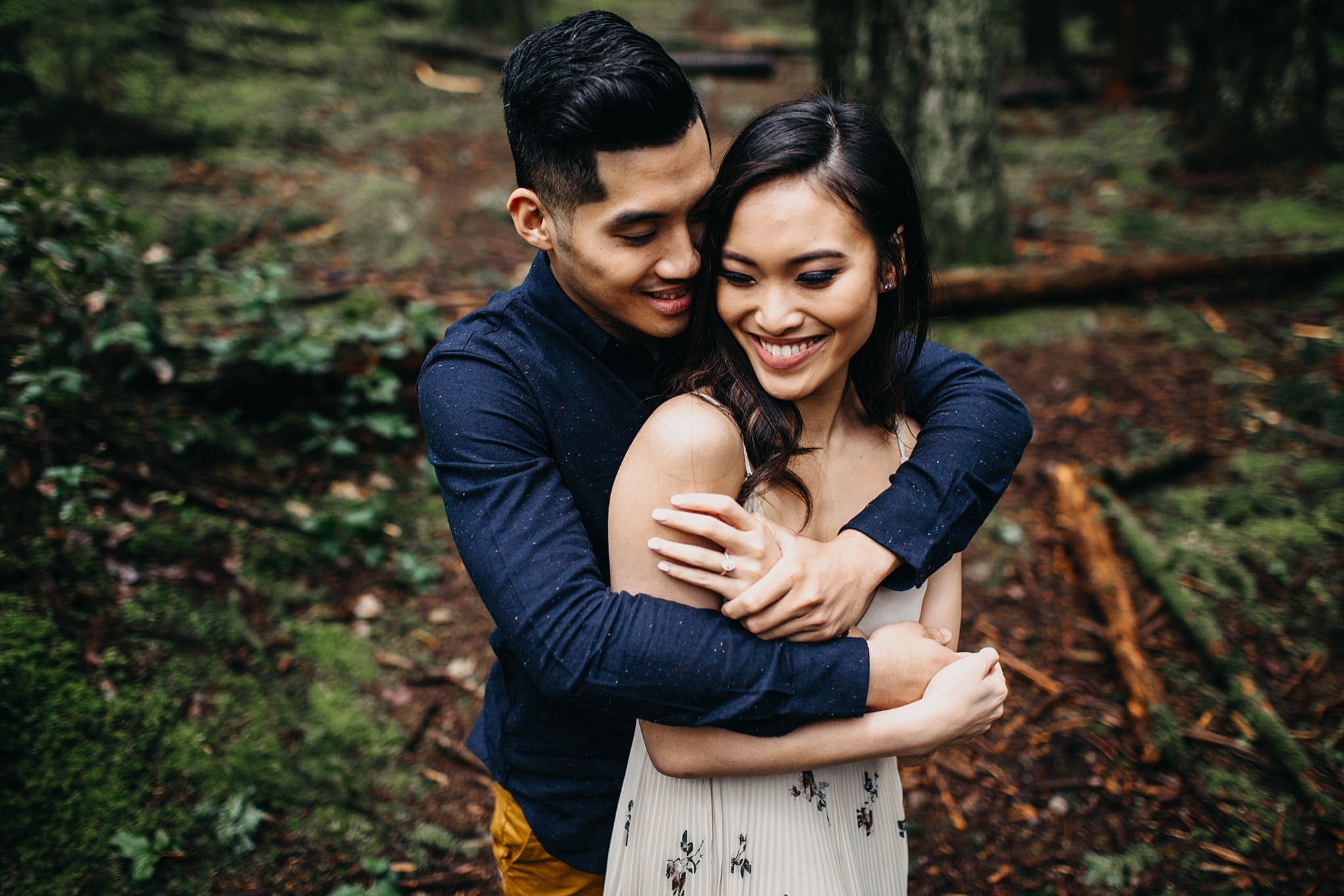 couple hugging in forest engagement session pacific spirit park