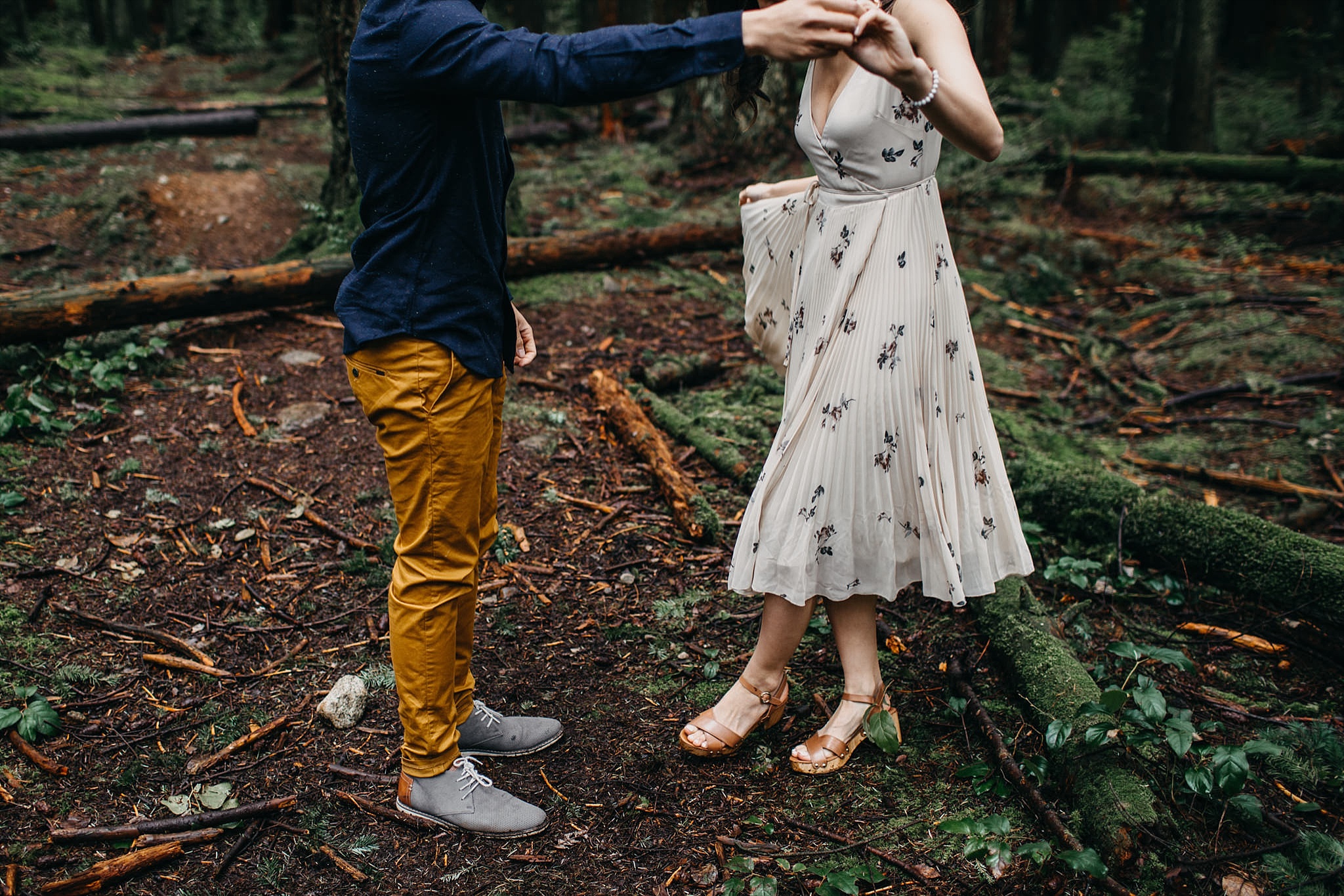 couple dancing feet in forest engagement session vancouver pacific spirit park