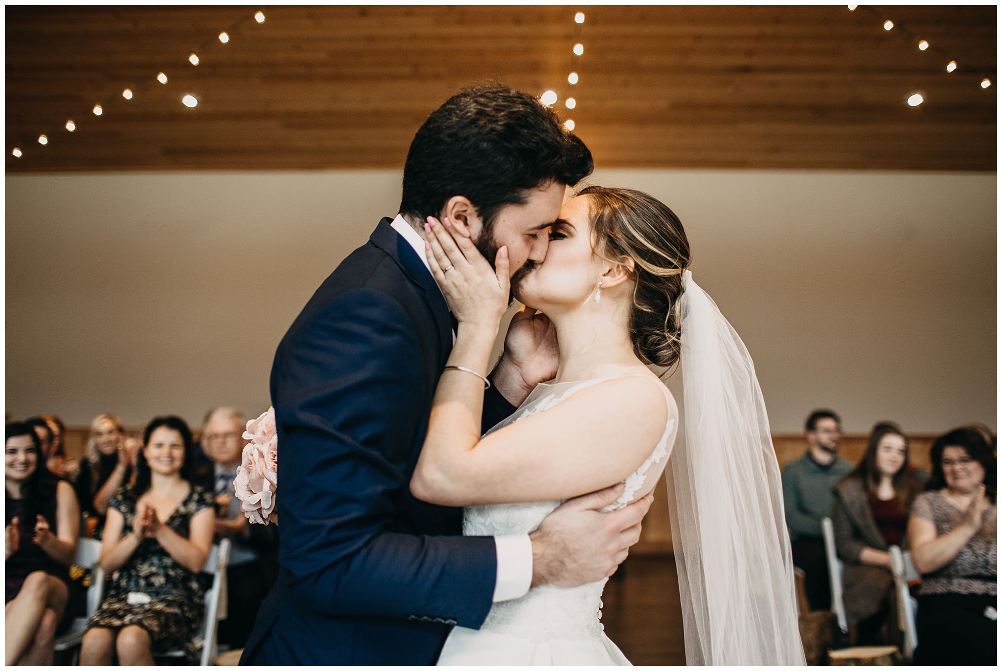 bride and groom first kiss at fraser river lodge wedding