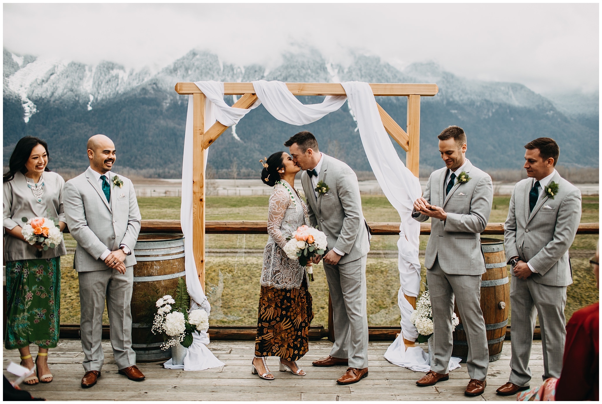 bride and groom first kiss at fraser river lodge wedding outside