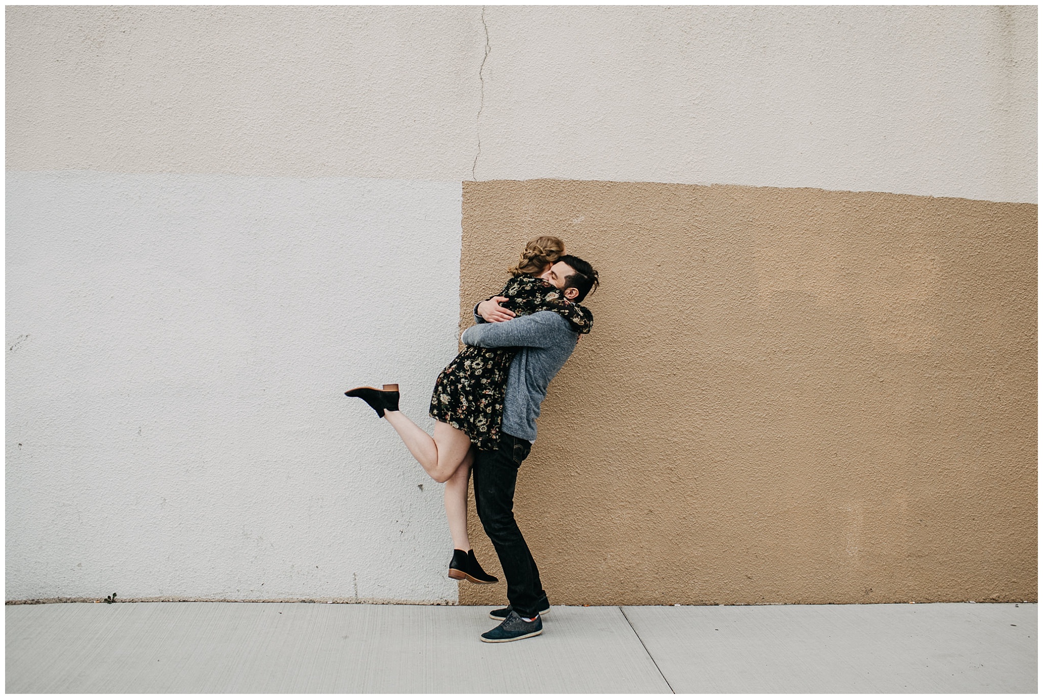 couple hugging in urban setting at downtown new west engagement session