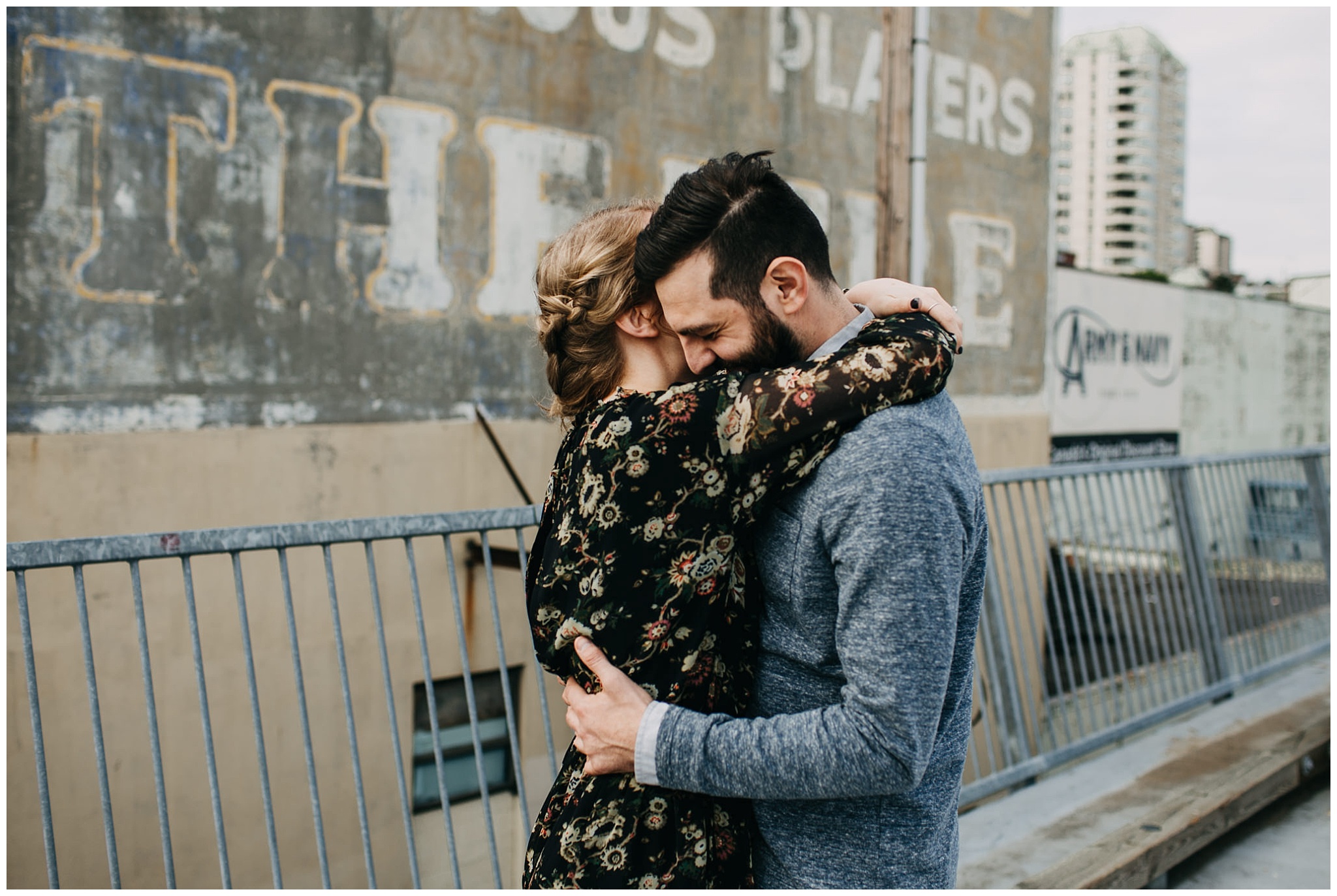 couple hugging on rooftop parkade at downtown new west engagement session