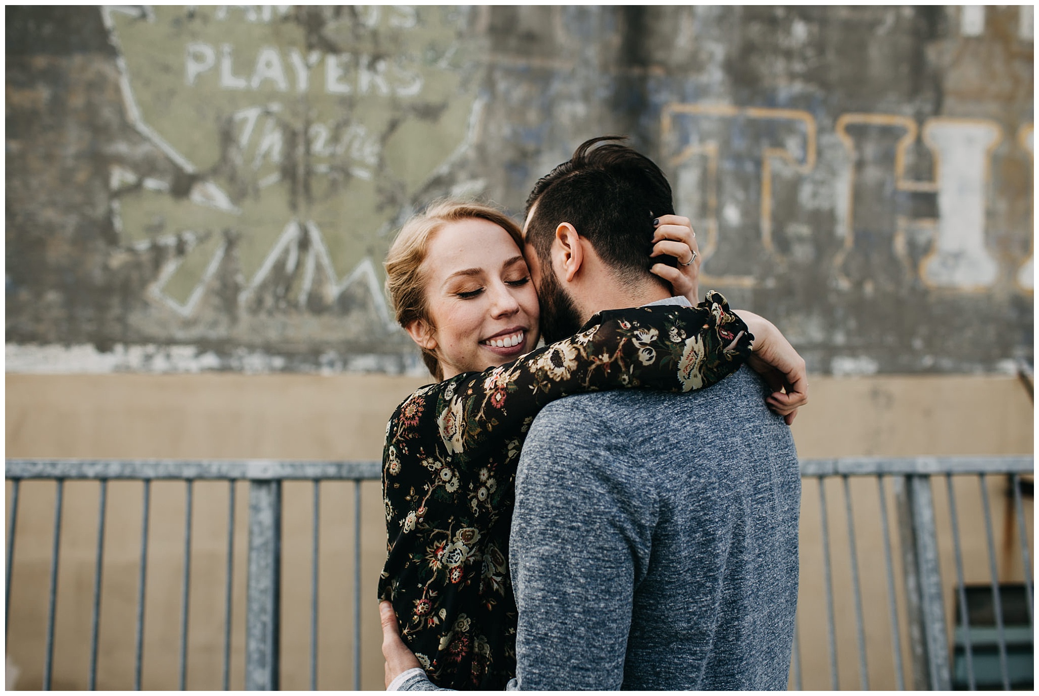 couple hugging on rooftop parkade at downtown new west engagement session