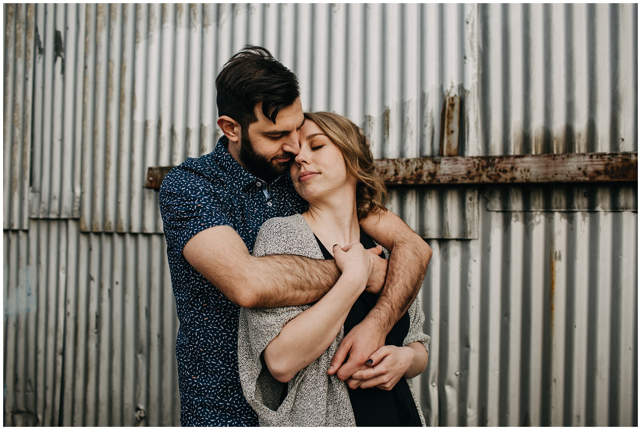 intimate couple photo in industrial setting at downtown new west engagement session