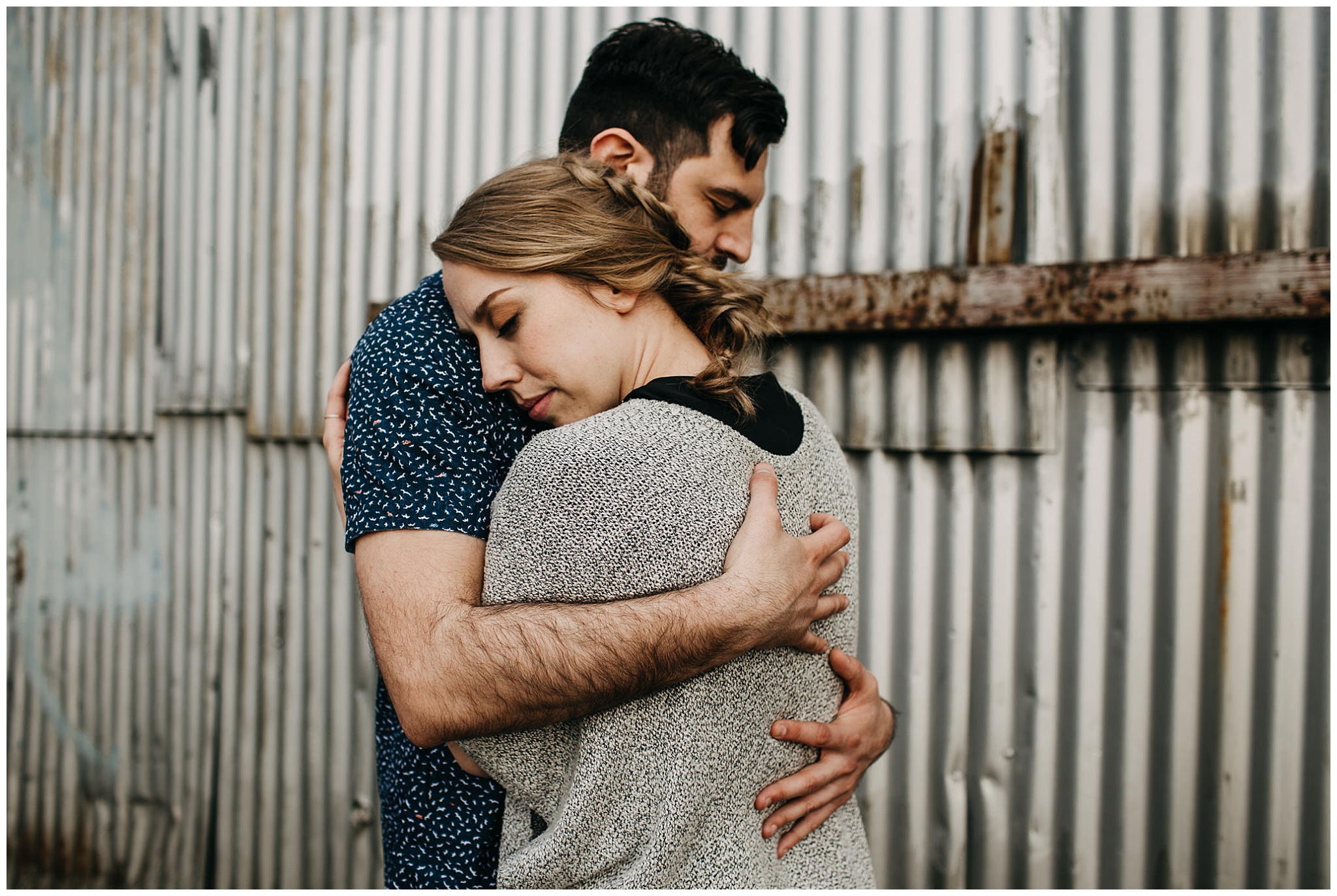 intimate couple photo in industrial setting at downtown new west engagement session