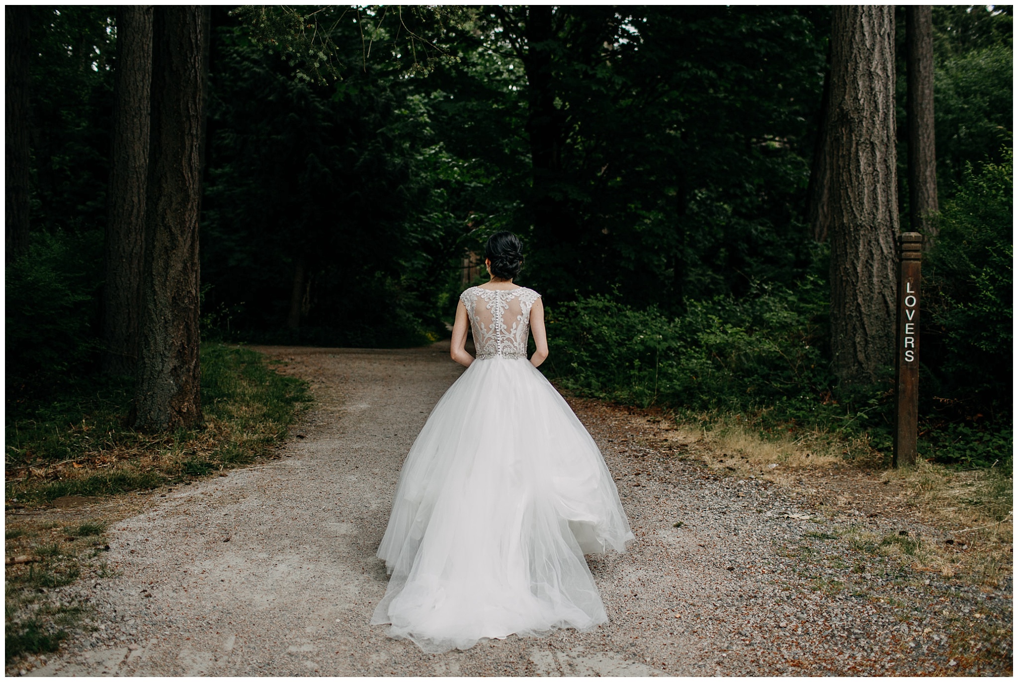bride walking in the forest to first look at stanley park wedding