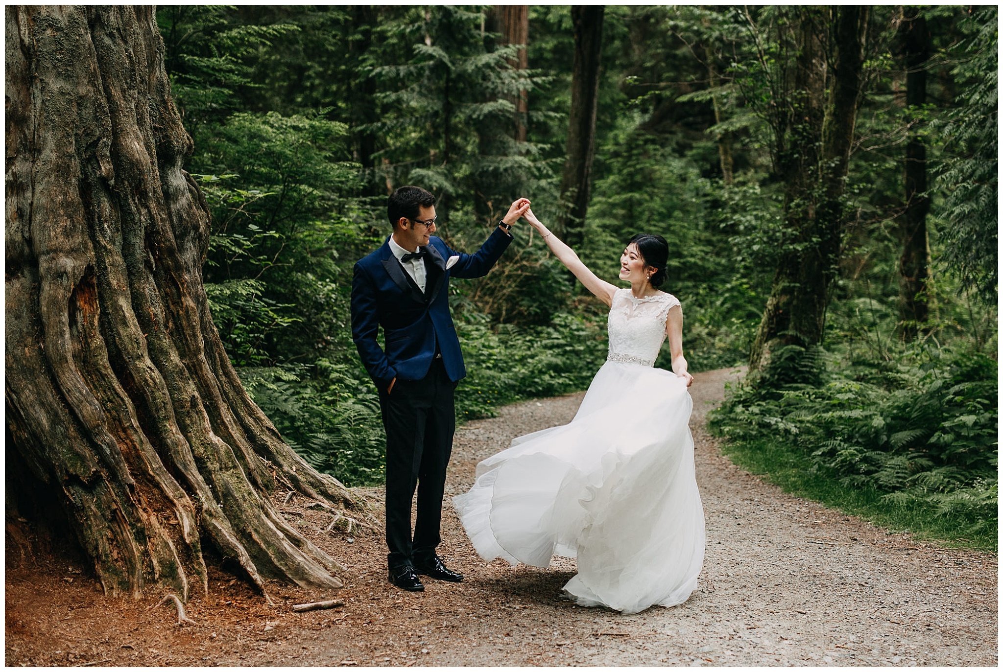 groom twirling bride in the forest at stanley park wedding