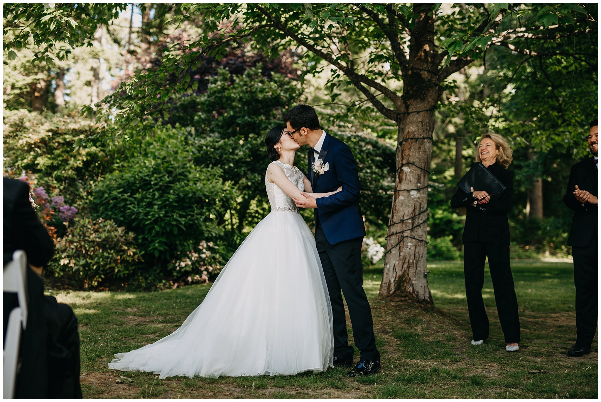 bride and groom first kiss at stanley park teahouse wedding