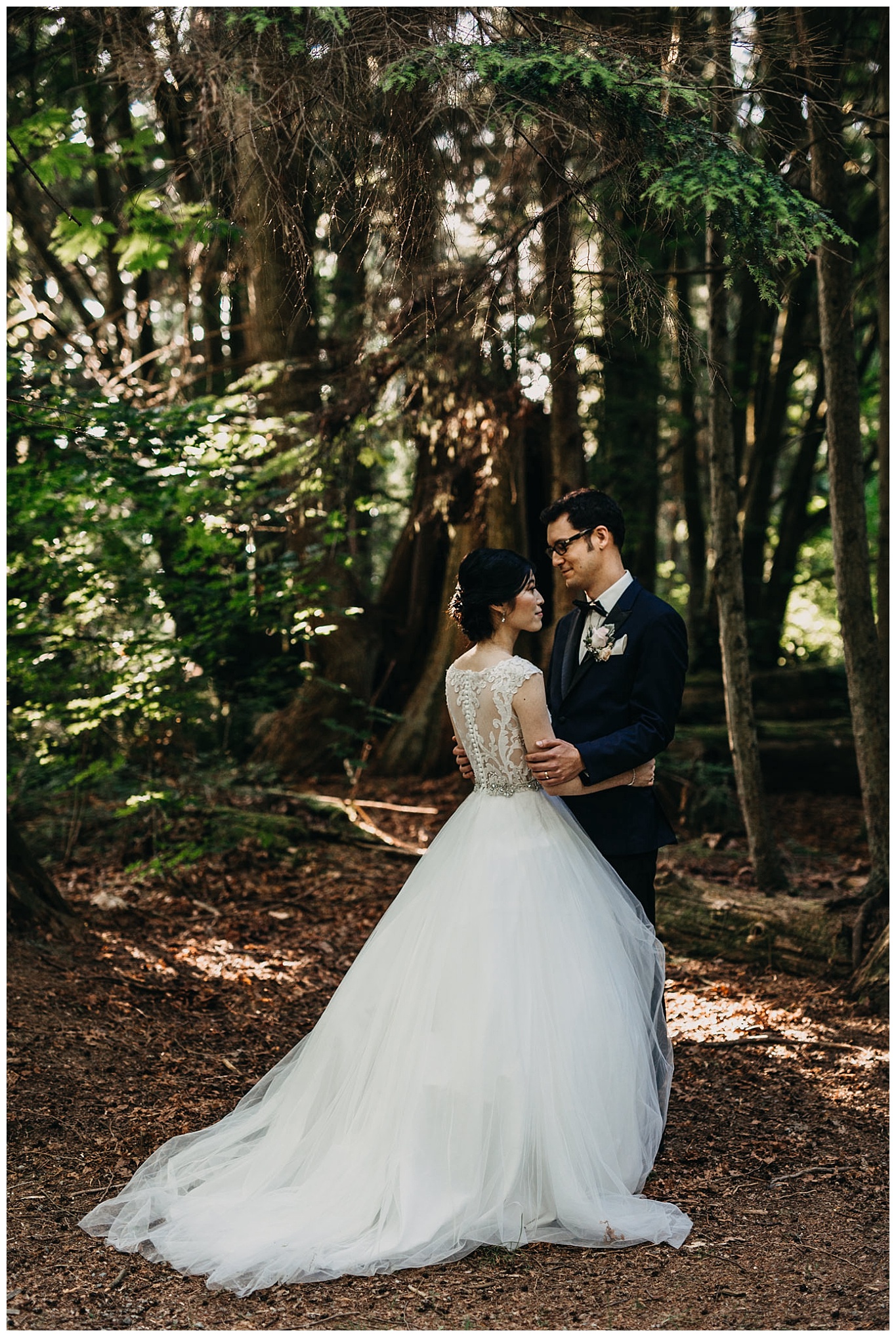 bride and groom portrait in the forest at stanley park teahouse wedding