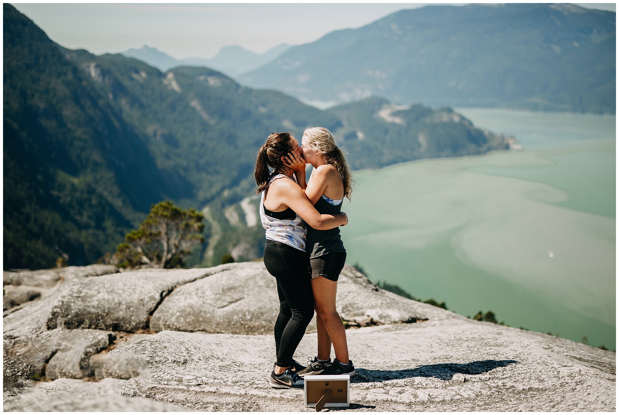 same sex couple kissing at proposal on the chief hike in squamish
