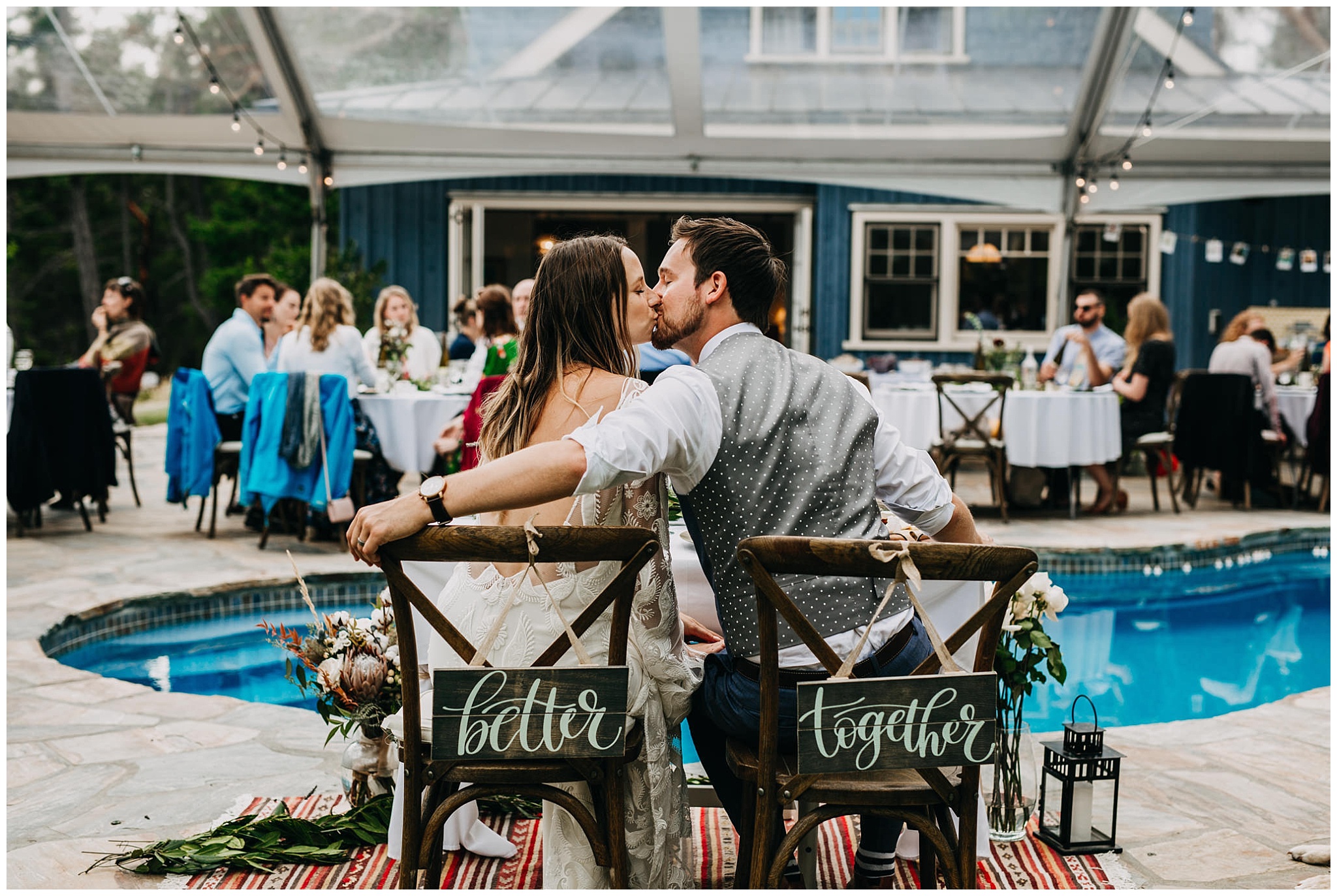 bride and groom kissing at mayne island backyard wedding reception