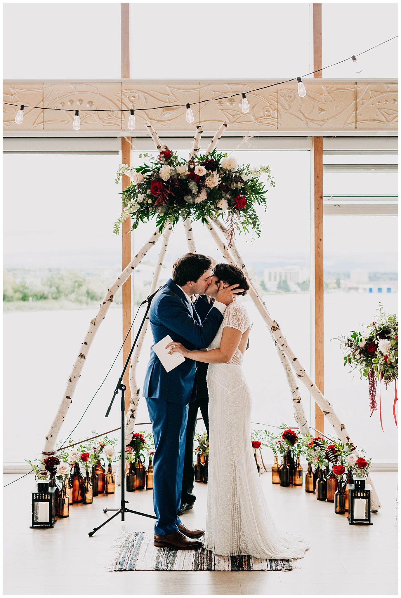 bride and groom first kiss at ubc boathouse wedding ceremony