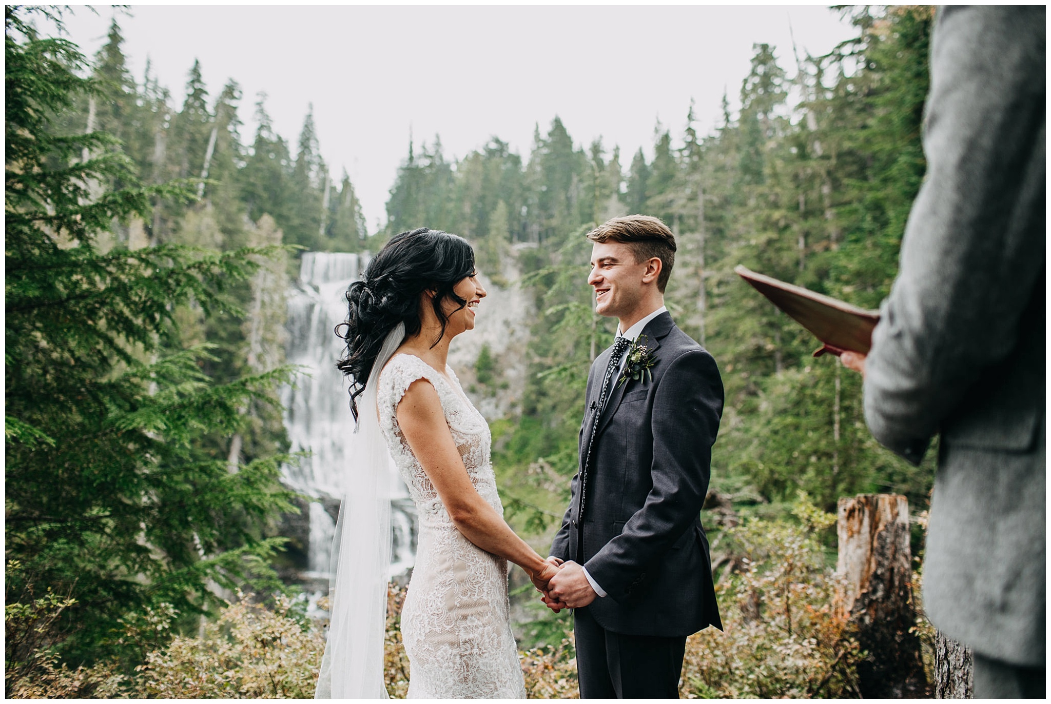 bride and groom in front of waterfall at whistler elopement