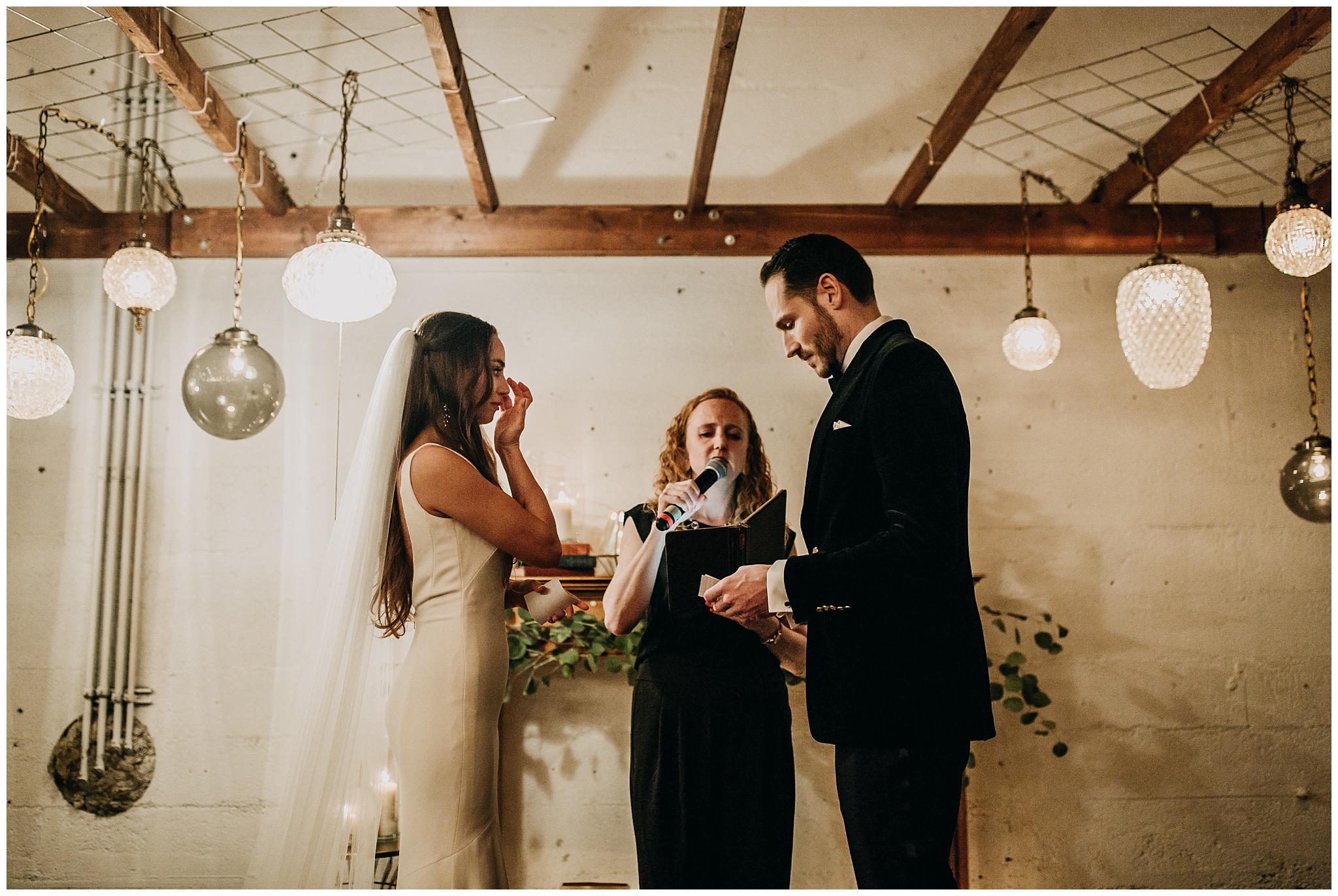 bride and groom vow exchange at settlement building wedding