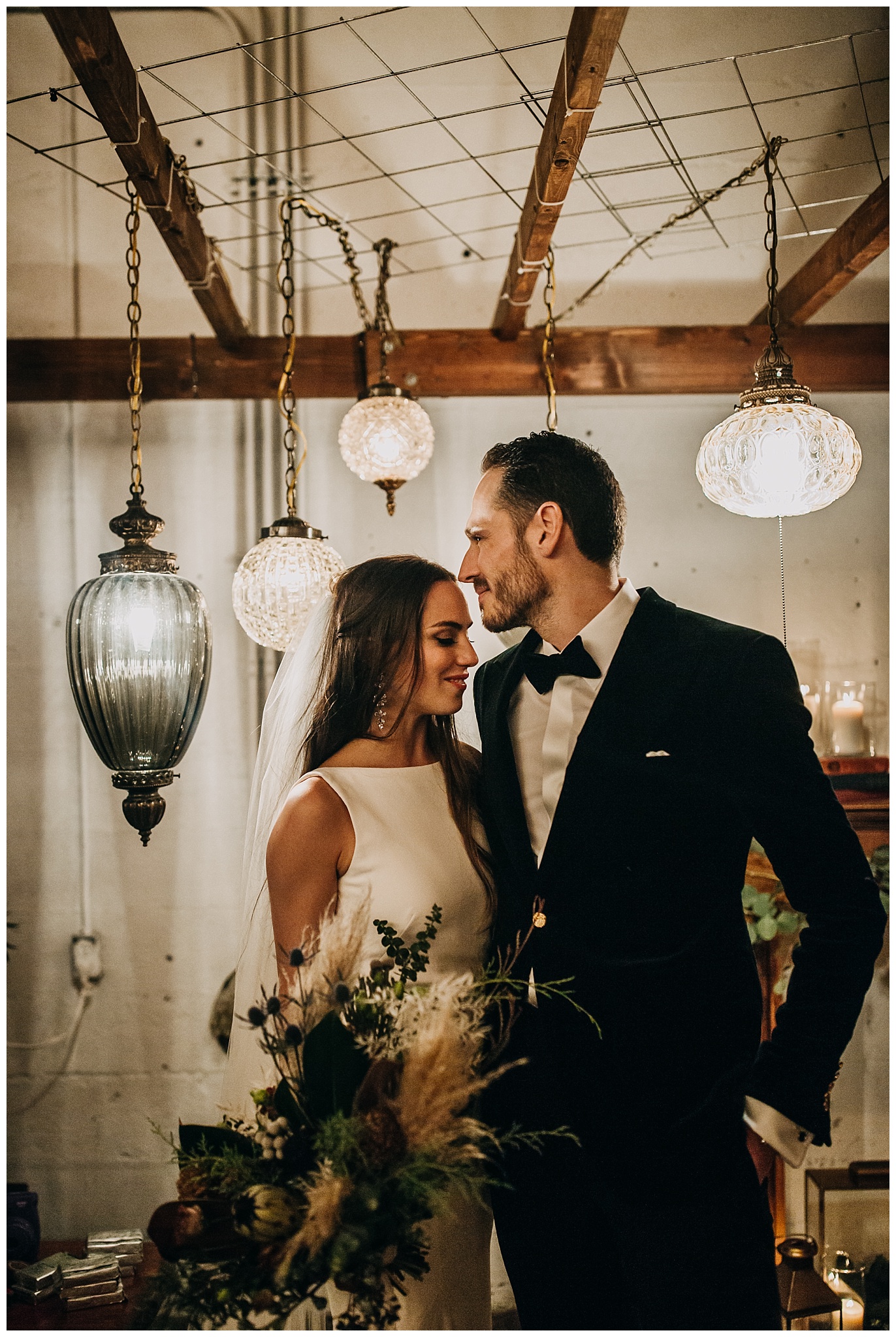 bride and groom portrait with lanterns at settlement building 