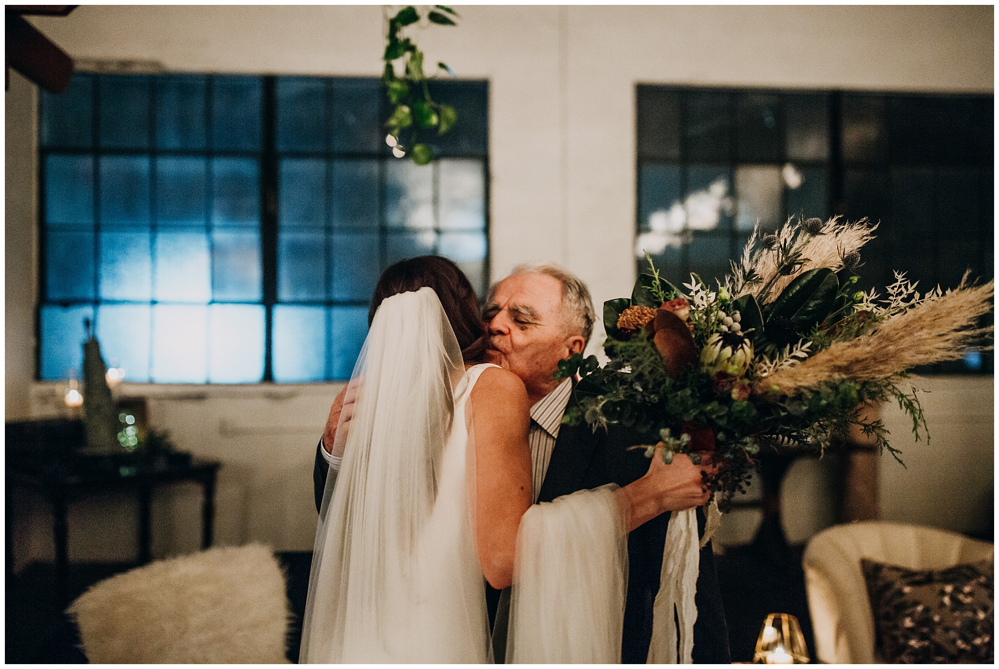 candid moment between bride and grandfather at settlement building