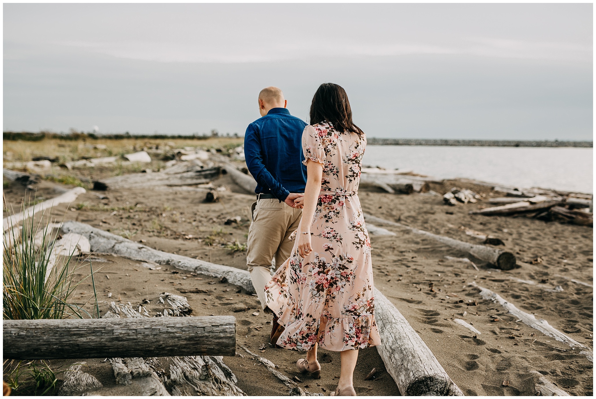couple walking on beach at iona beach vancouver engagement