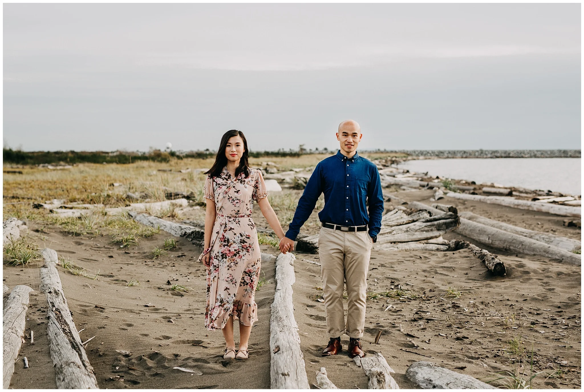 couple holding hands on beach at iona beach vancouver