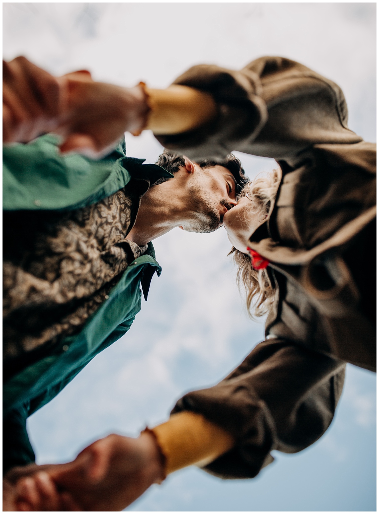 creative perspective of couple kissing at jericho beach engagement session