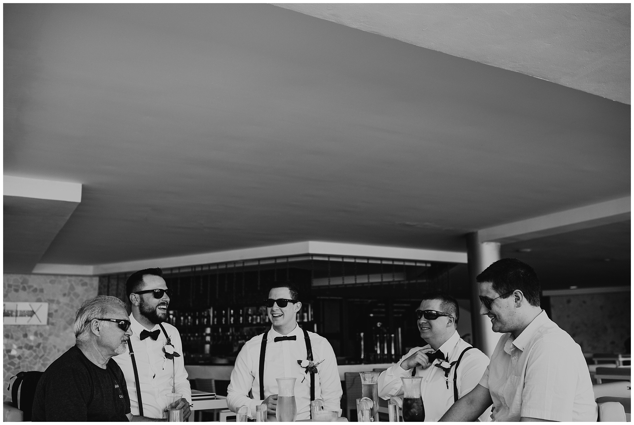 Groom and groomsmen drinking at bar at cancun mexico wedding