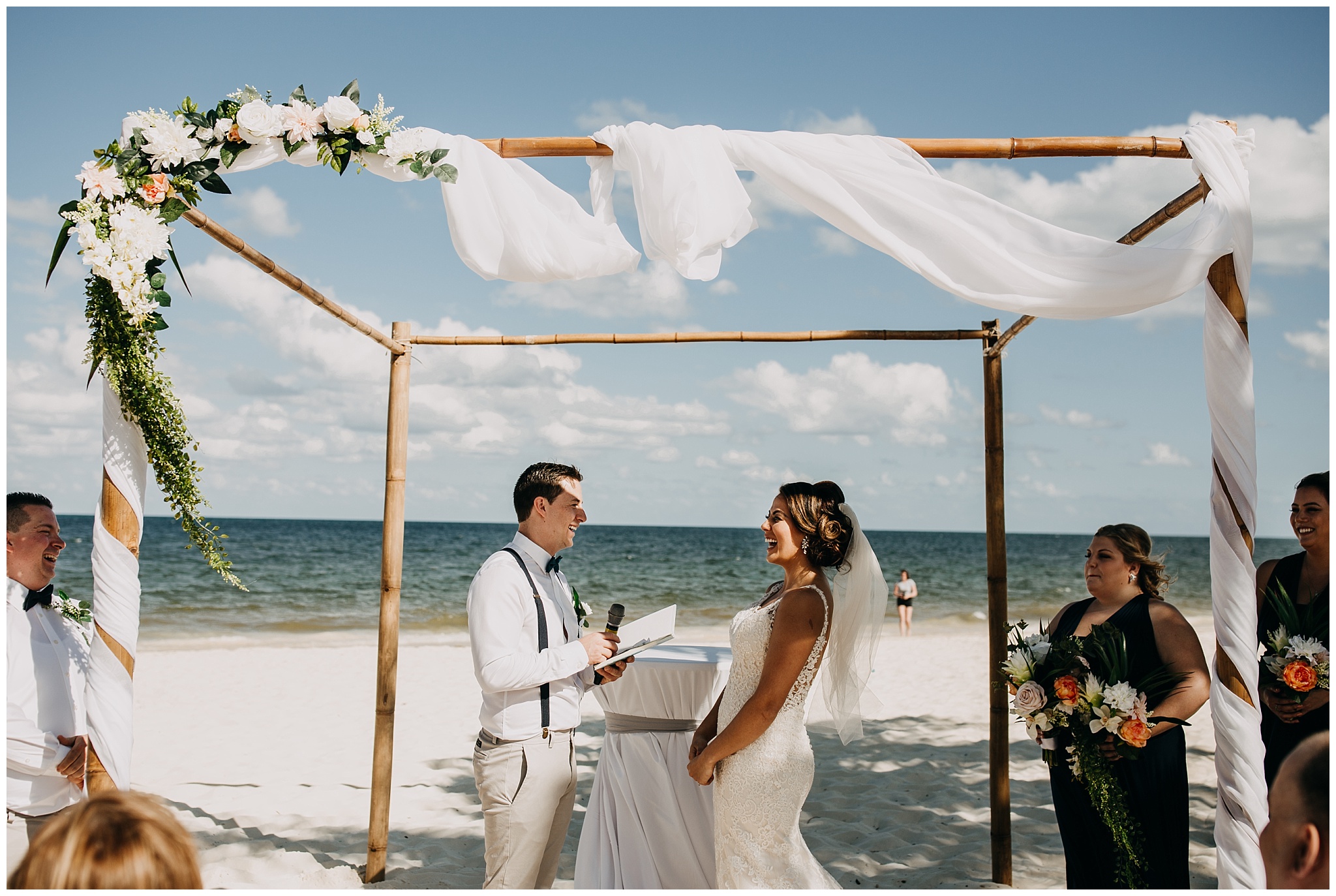 bride and groom exchange vows on the beach at cancun mexico wedding ceremony